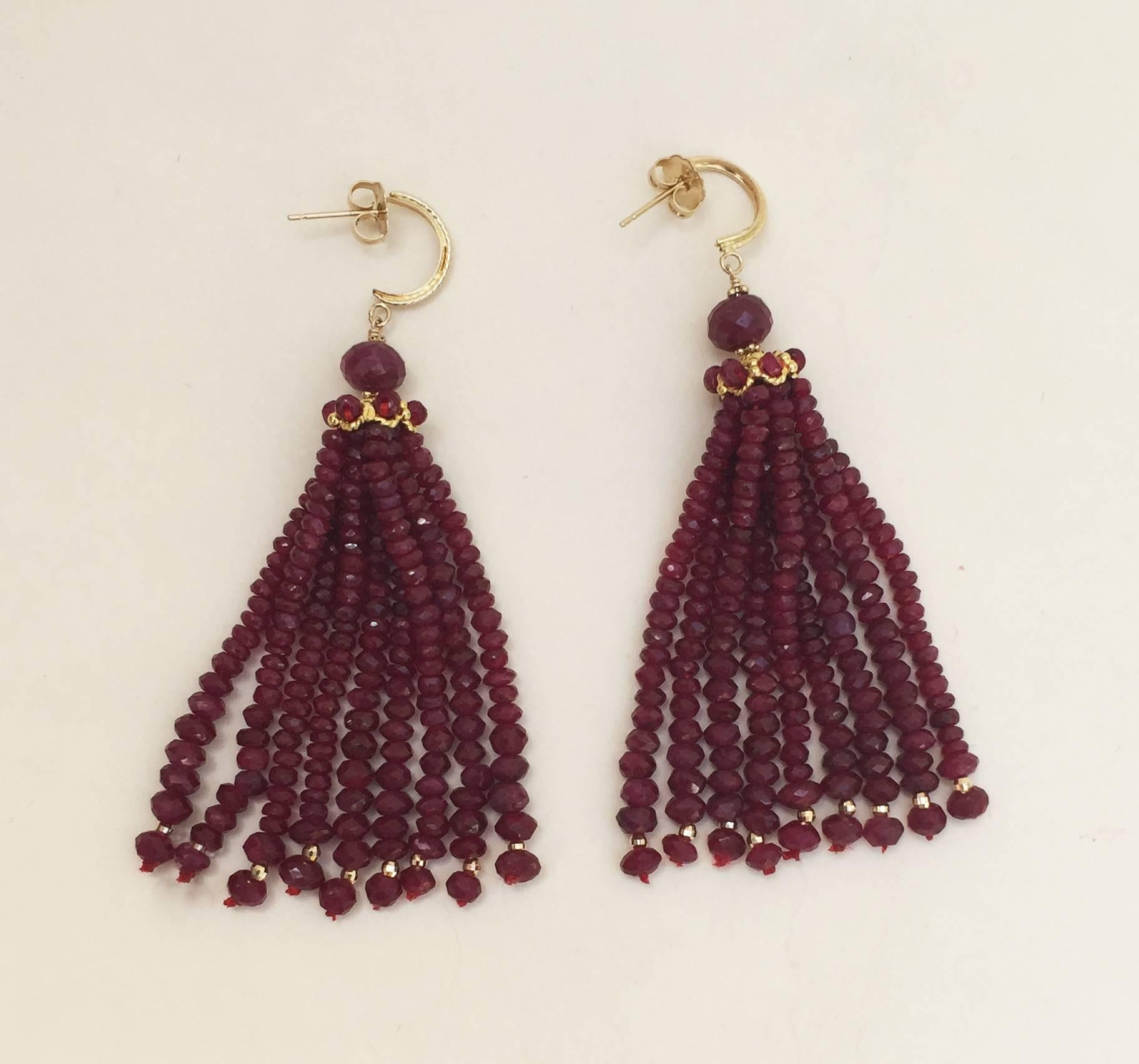 The rich red of the faceted ruby beads are accented by the tiny faceted 14k yellow gold beads at the bottom of each graduated strand (1-3mm). The earrings are almost three inches with a larger ruby faceted bead, 14k yellow gold cap, and stud