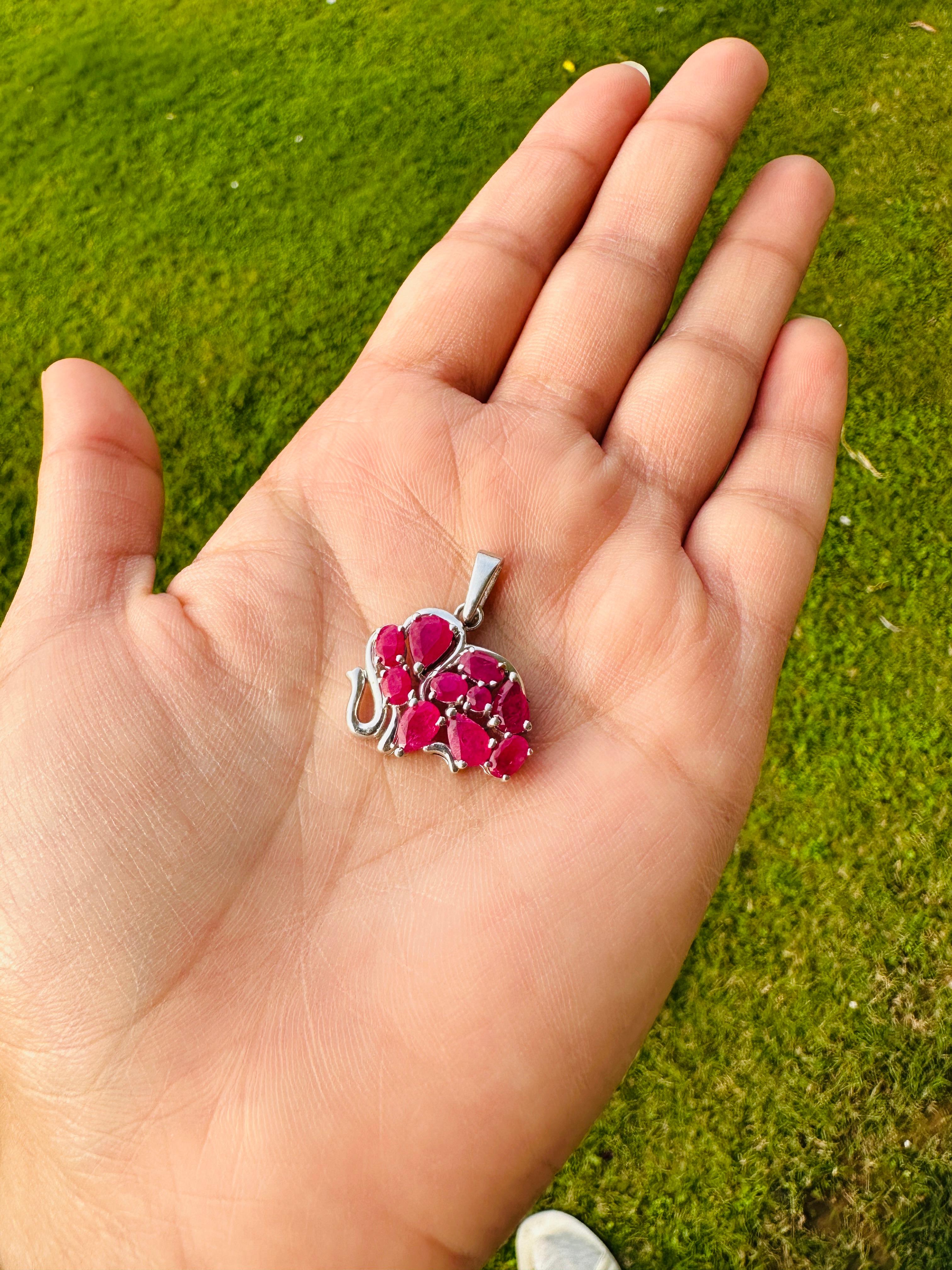 Ruby Birthstone Sterling Silver Elephant Pendant in sterling silver studded with round, pear, oval cut ruby. This stunning piece of jewelry instantly elevates a casual look or dressy outfit. 
Ruby enhances the intellectual capacity of the
