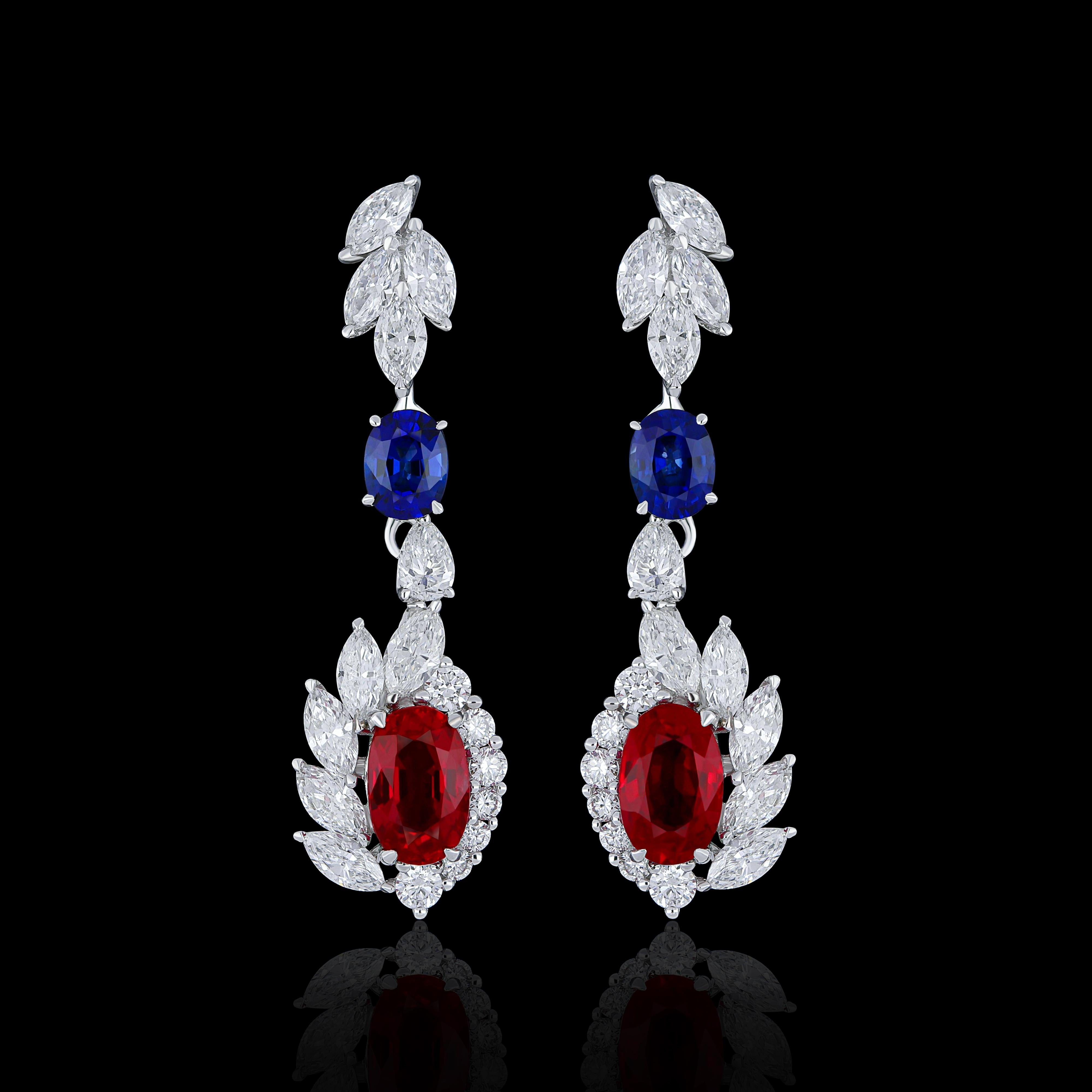 Elegant and exquisitely detailed 18 Karat White Gold Earring, center set with 1.26Cts .Oval Shape Vibrant Red Ruby, and Royal Blue Sapphire weighing approx. 0.51Cts accented with micro pave set Diamonds, weighing approx. 1.35 Cts Beautifully Hand