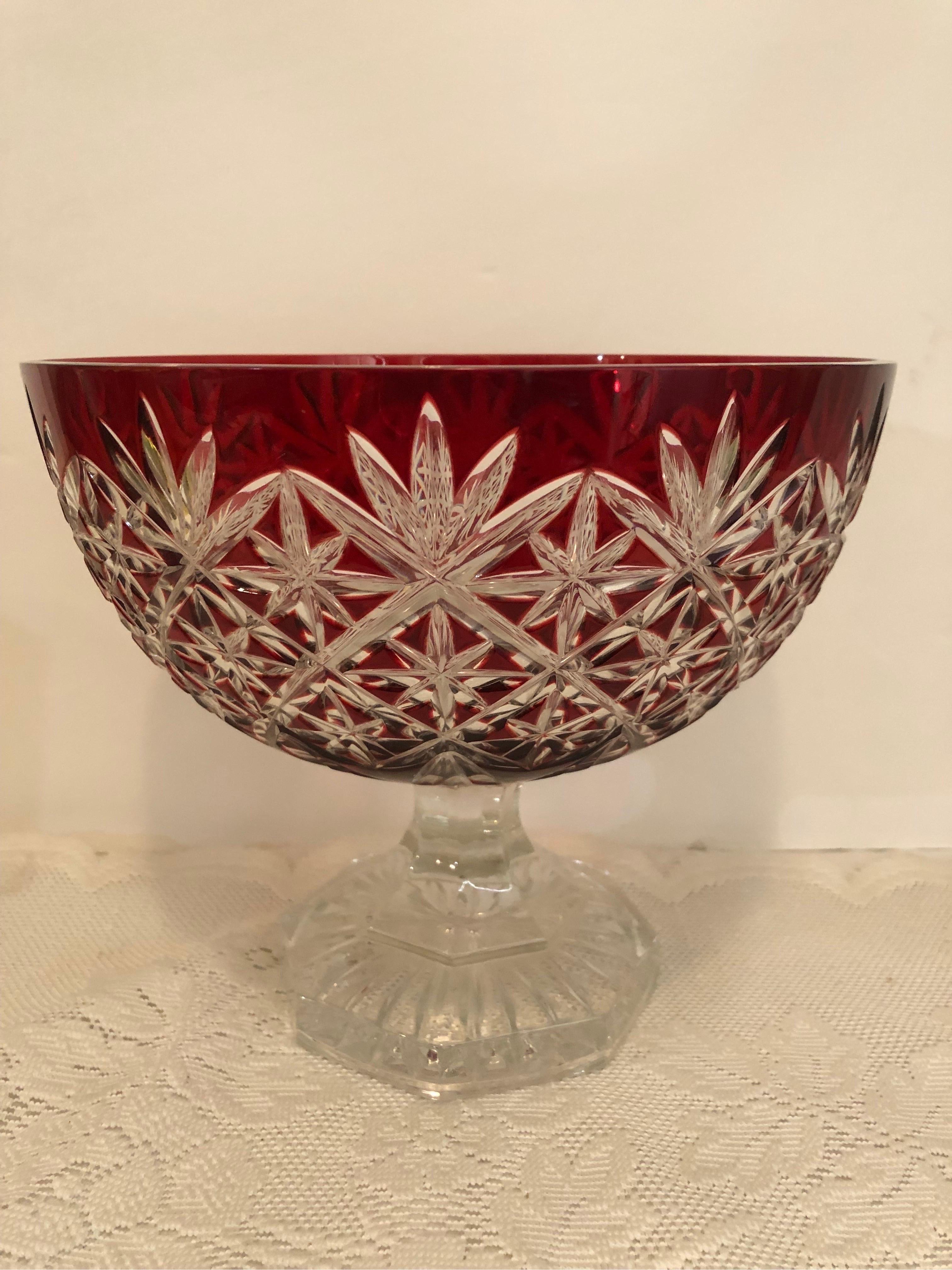 This is a spectacular ruby cut Bohemian Czechoslovakian centerpiece bowl on a clear-cut pedestal base. The main upper bowl is ruby red, and the base is clear cut crystal. It would make a stunning centerpiece bowl for the center of a table or as a