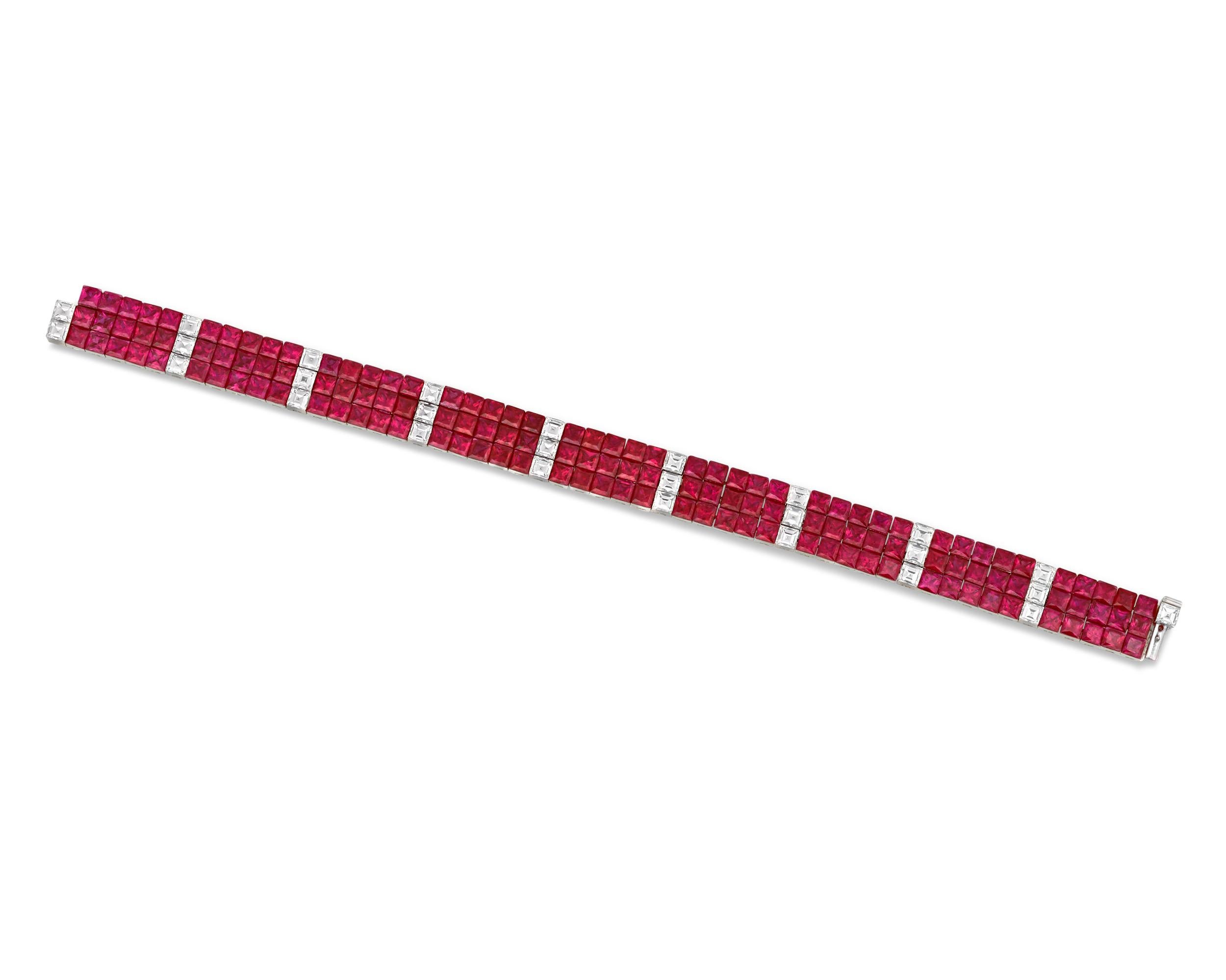 The extraordinary design of this bracelet incorporates 31.37 total carats of vibrant rubies that cascade beautifully around the wrist. The princess-cut gemstones' invisible platinum setting allows the bracelet to move with a supple elegance,