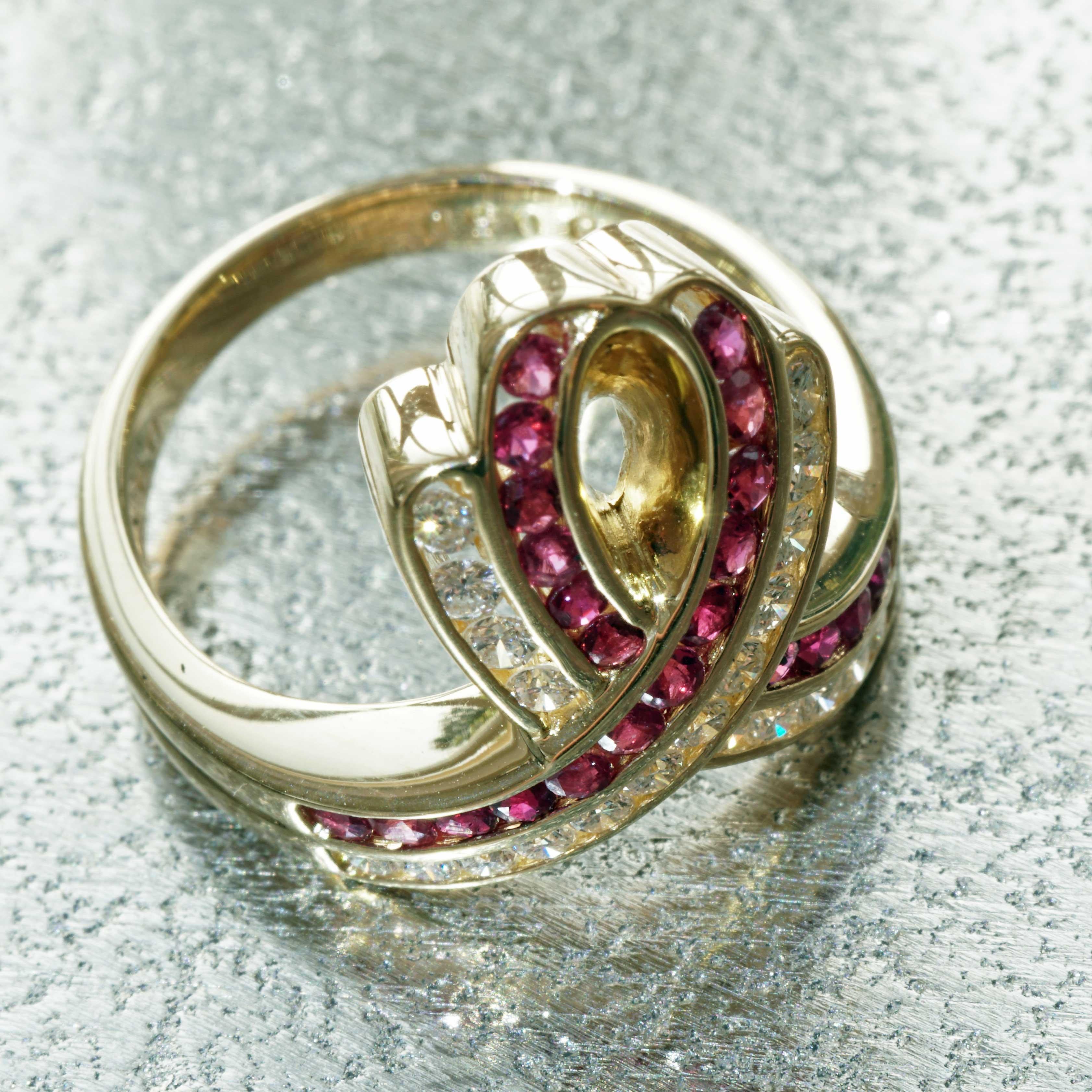 with momentum into life, the shape encourages dancing, large loop set with very fine, intensely colored rubies totaling approx. 0.50 ct, full cut brilliant-cut diamonds totaling approx. 0.38 ct, TW (fine white) / IF-VVS ( flawless - very very small