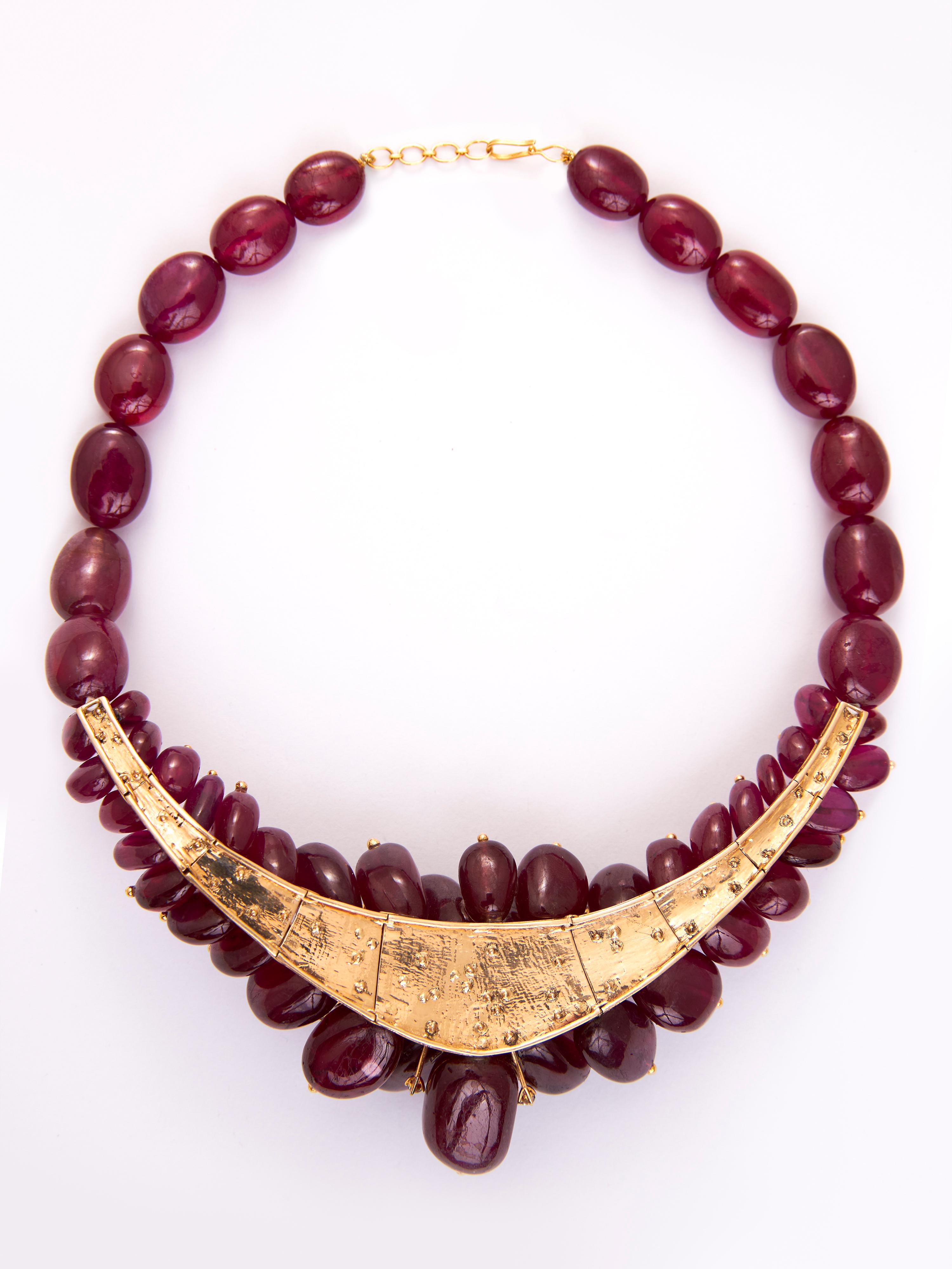 Step into celestial opulence with the Ruby Burst Necklace from the Akasa Collection, a radiant symbol of power, vitality, and sophistication. Expertly crafted in 18KT gold, this luxurious masterpiece weighs 146.82 grams and showcases a magnificent