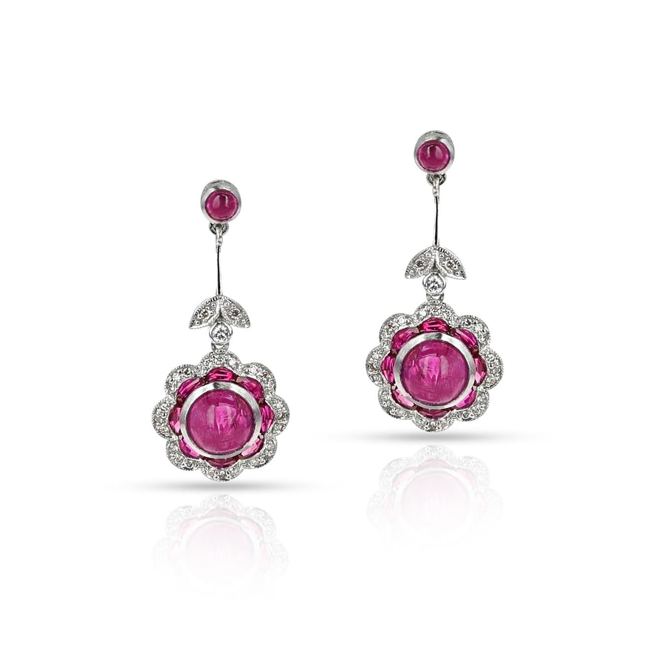 A pair of Ruby Cabochon and Diamond Earrings made in Platinum. The total weight is 7.50 grams. The large ruby cabochons weigh 4.45 carats. The small ruby cabochons weigh 0.53 carats. 

