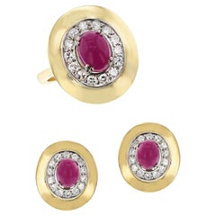 Set di anelli e orecchini con cabochon di rubino e diamanti, 18k e palladio