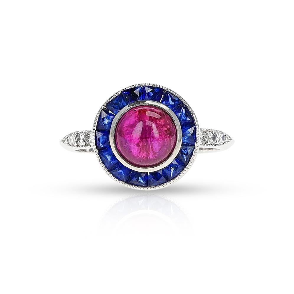 SKU 1180

A Ruby Cabochon Diamond and Sapphire Ring, Platinum. The center ruby weighs 1.90 carats. The total weight of the ring is 4.84 grams. The ring size is US 6. 
