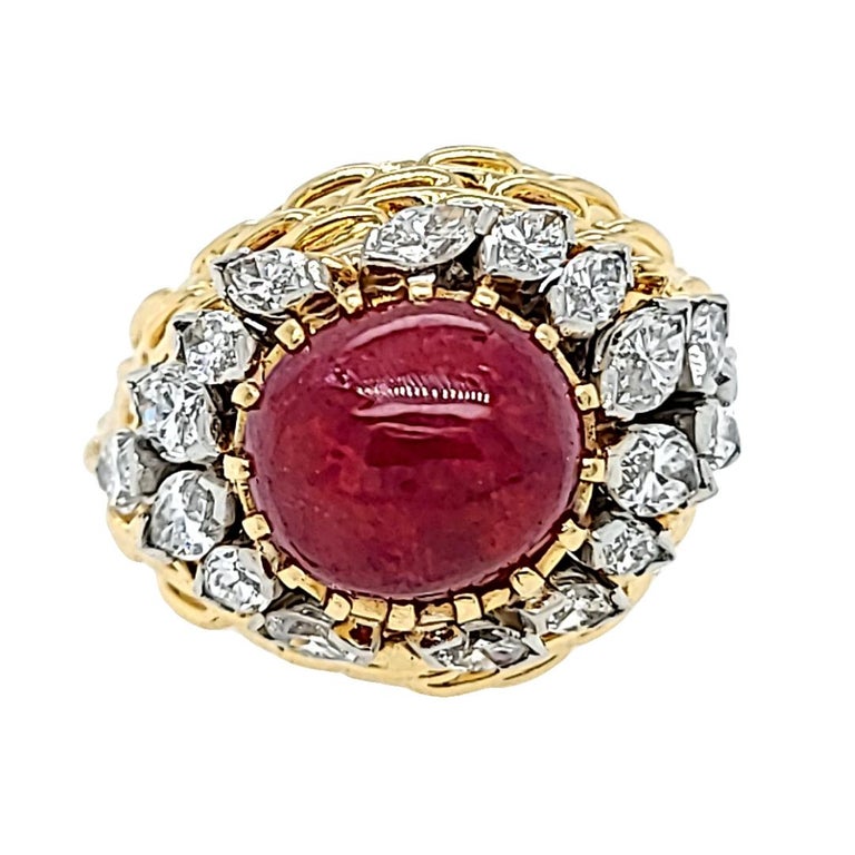 18 Karat Yellow Gold Dome Ring Featuring A 6 Carat Cabochon Ruby Accented By 18 Marquise Cut Diamonds Of VS Clarity and H Color Totaling Approx 1.00 Carat. Finger Size 6.5; Purchase Includes One Sizing Service Prior to Shipment. Finished Weight Is