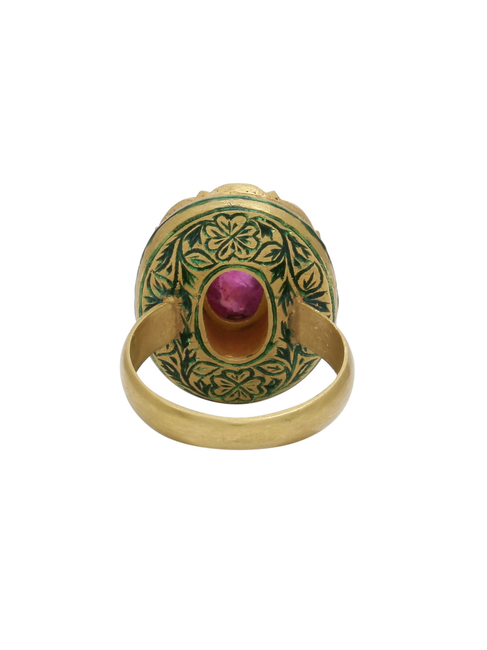 A natural pink Ruby Cabochon set in 22k Gold with uncut diamonds all around making a beautiful cocktail ring. You will also notice intricate enamel work at the back of the ring which is traditional from the region of Jaipur, India. The Ring is all