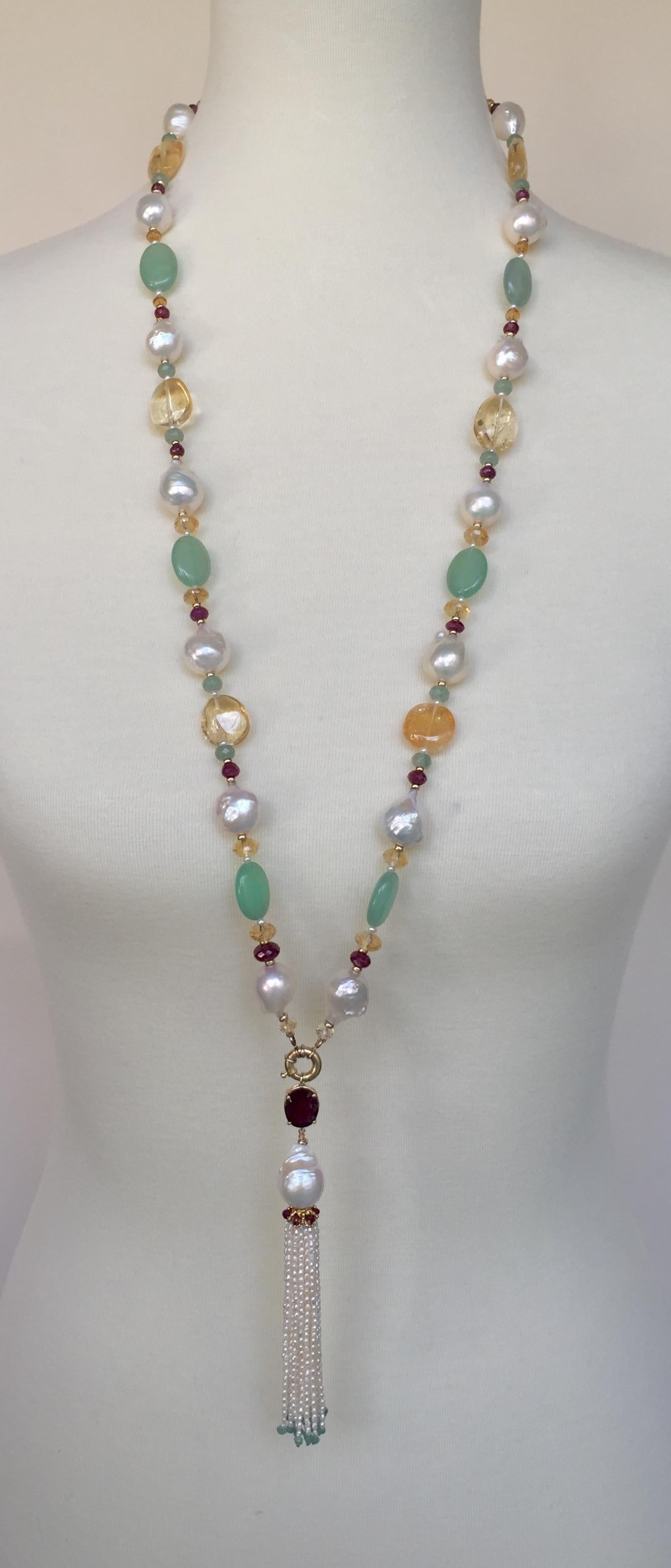 Glittering ruby, citrine, 14k yellow gold and apaptite complete this sautoir necklace with removable tassel. The warm tones of the 14k yellow gold beads, ruby stones, and citrine go  with the cooler toned of the white pearls, apatite, and green
