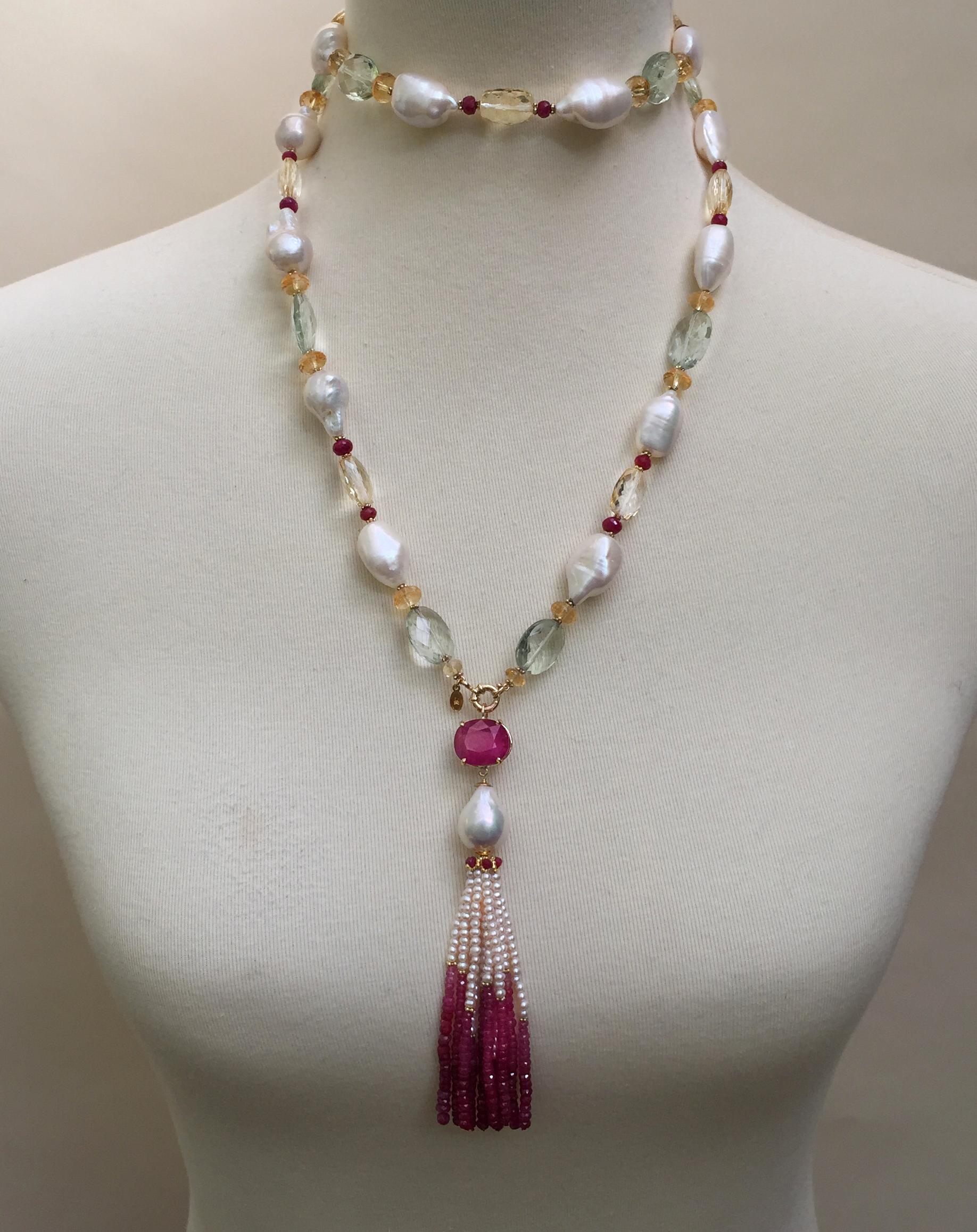 Vibrant ruby, citrine, topaz and 14k yellow gold beads are accented by a faceted ruby, pearl, and 14k gold tassel, creating a beautiful necklace. The centerpiece of the necklace is a striking red 15.77 carat oval faceted ruby and white oval pearl