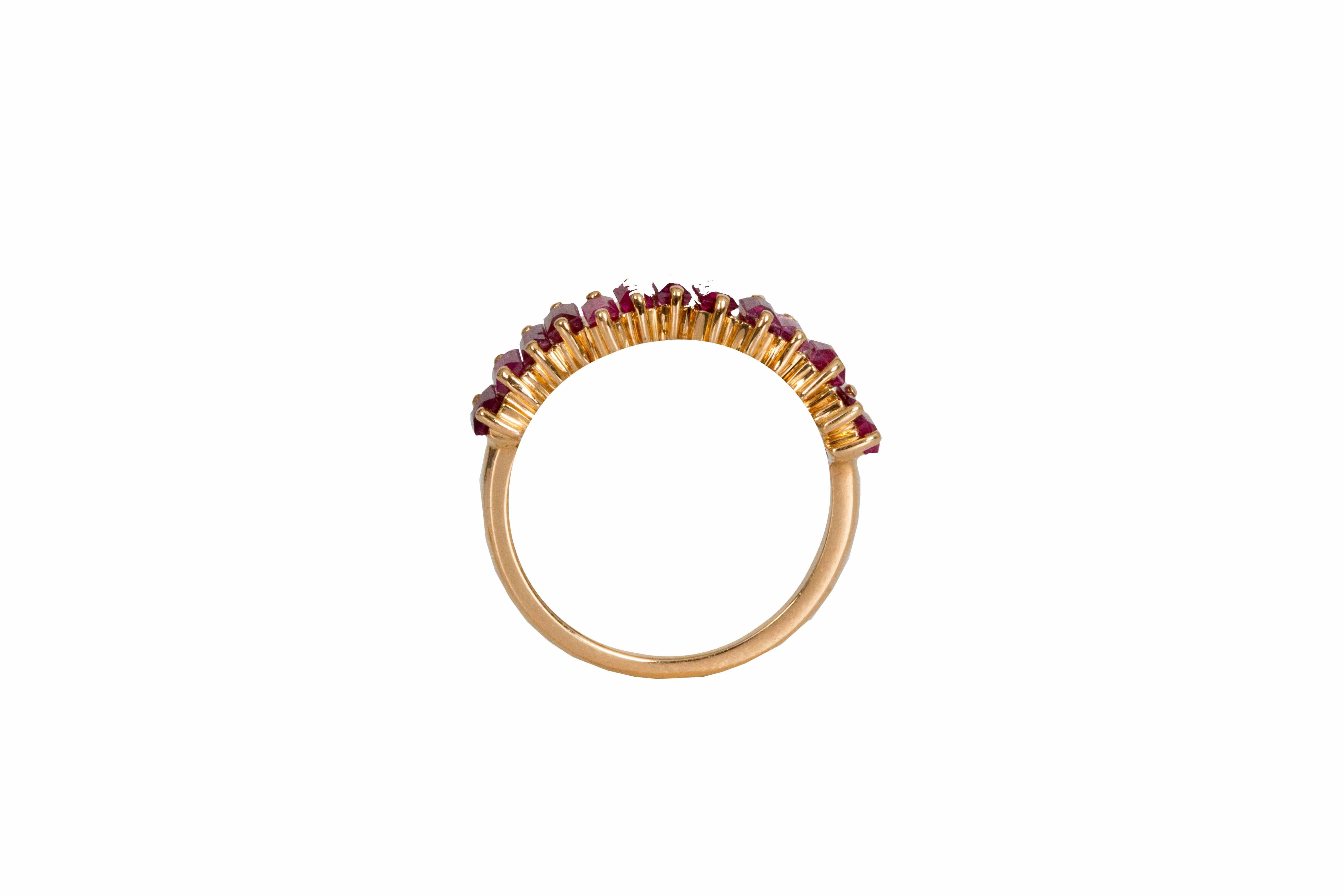 18 carat white gold band with 14 baguette cut rubies weighing 1.50 carats total. Our rubies are hand selected by our team of experts and carefully set unevenly to create a fascinating composition. A twist on tradition this 