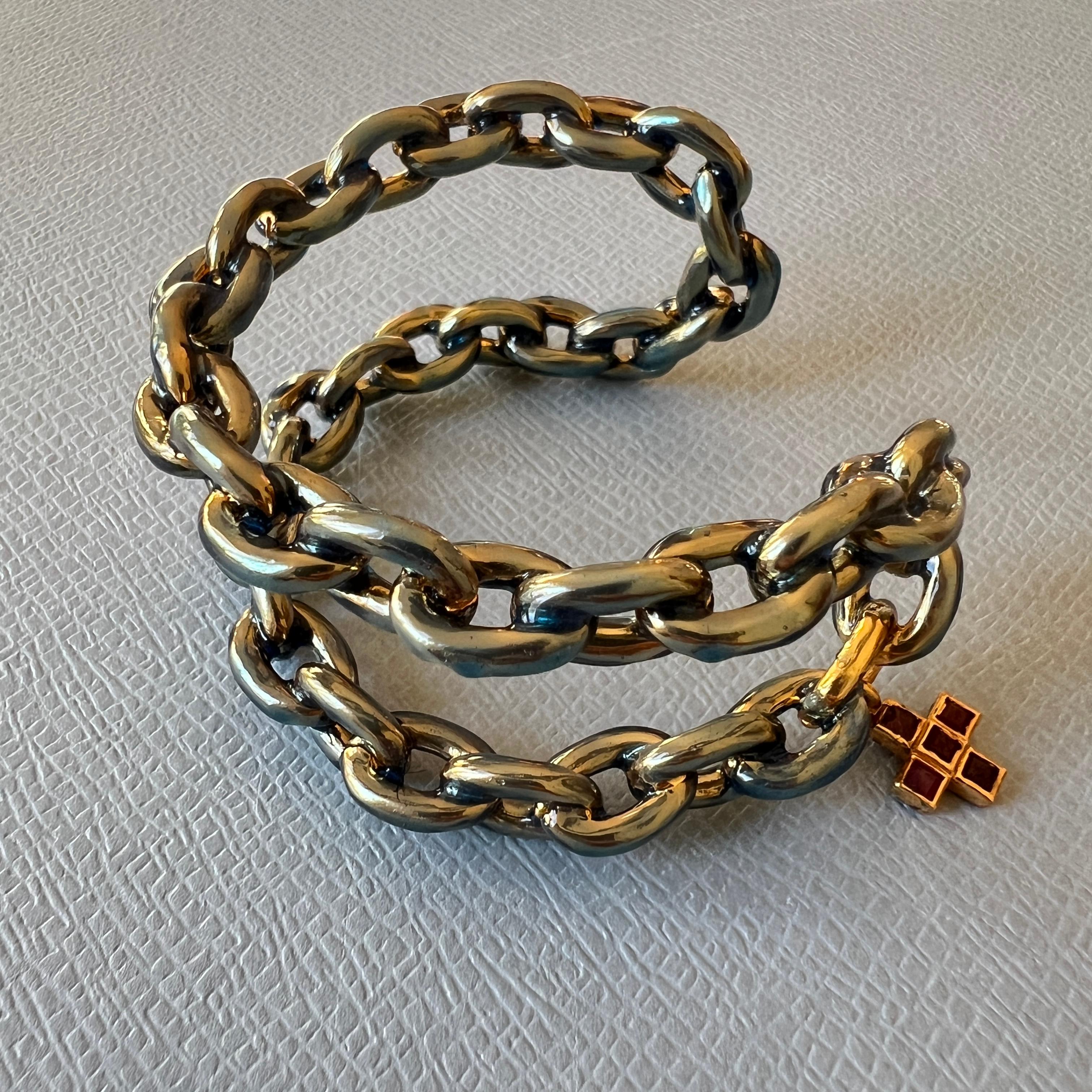 Ruby Cross Pendant Hand soldered Double Chain Statement Cuff Bangle with Handpainted Light Blue Enamel on 18 K Gold Plated Brass

This cuff bangle, crafted from 18-karat gold-plated brass, merges thoughtful design with rich symbolism. Its