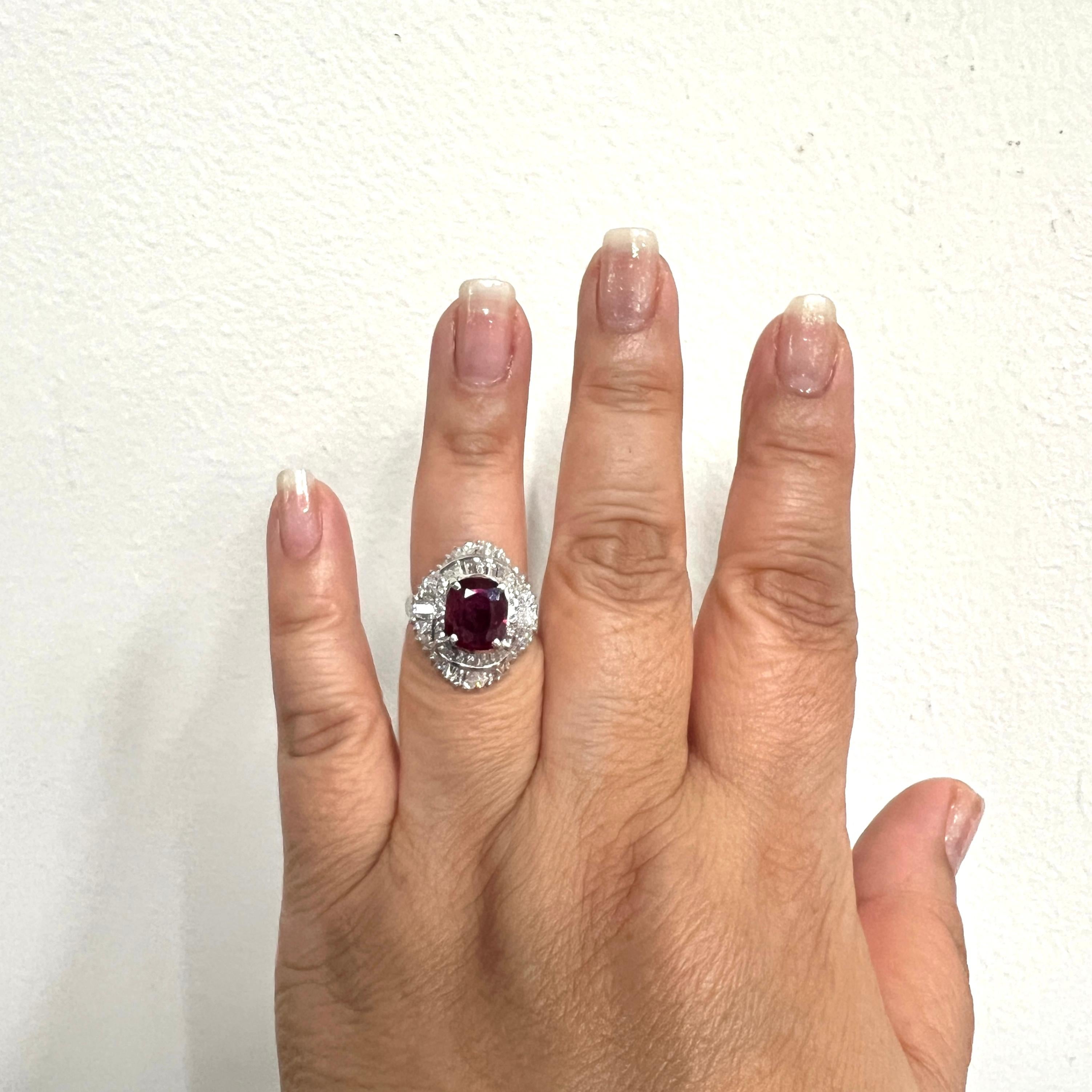 Beautiful 2.70 ct. ruby cushion with 2.13 ct. good quality white diamond baguettes and rounds.  Handmade in platinum.  Ring size 6.5.