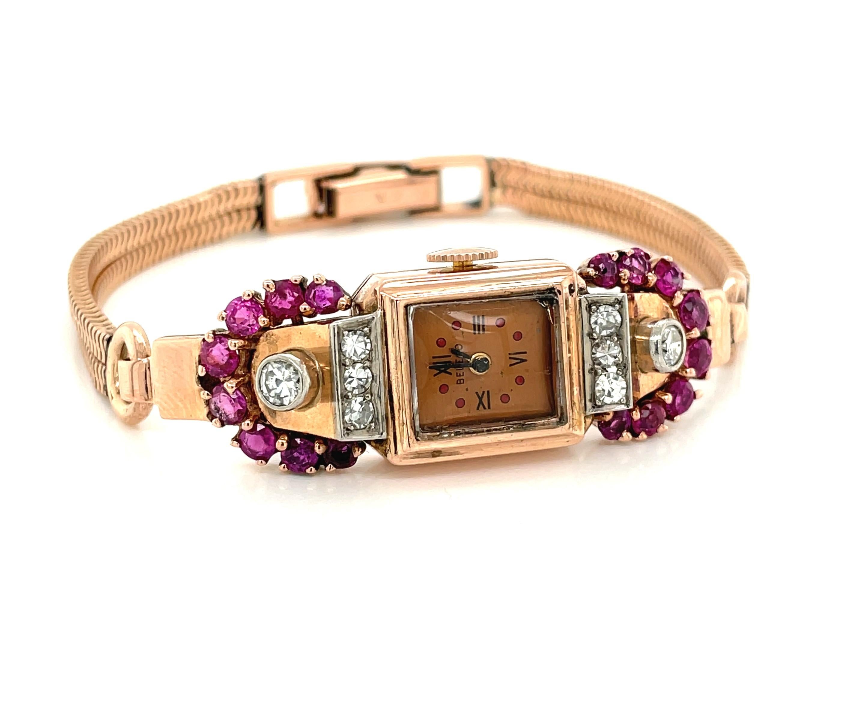 Glorious Art Deco feminine finery in 14 karat rose gold, this elegant vintage timepiece is adorned with .80 carats TW of Old Mine cut Rubies and .50 carats TW round faceted Diamonds. A Swiss made manual wind 17 jeweled movement watch by Belco keeps