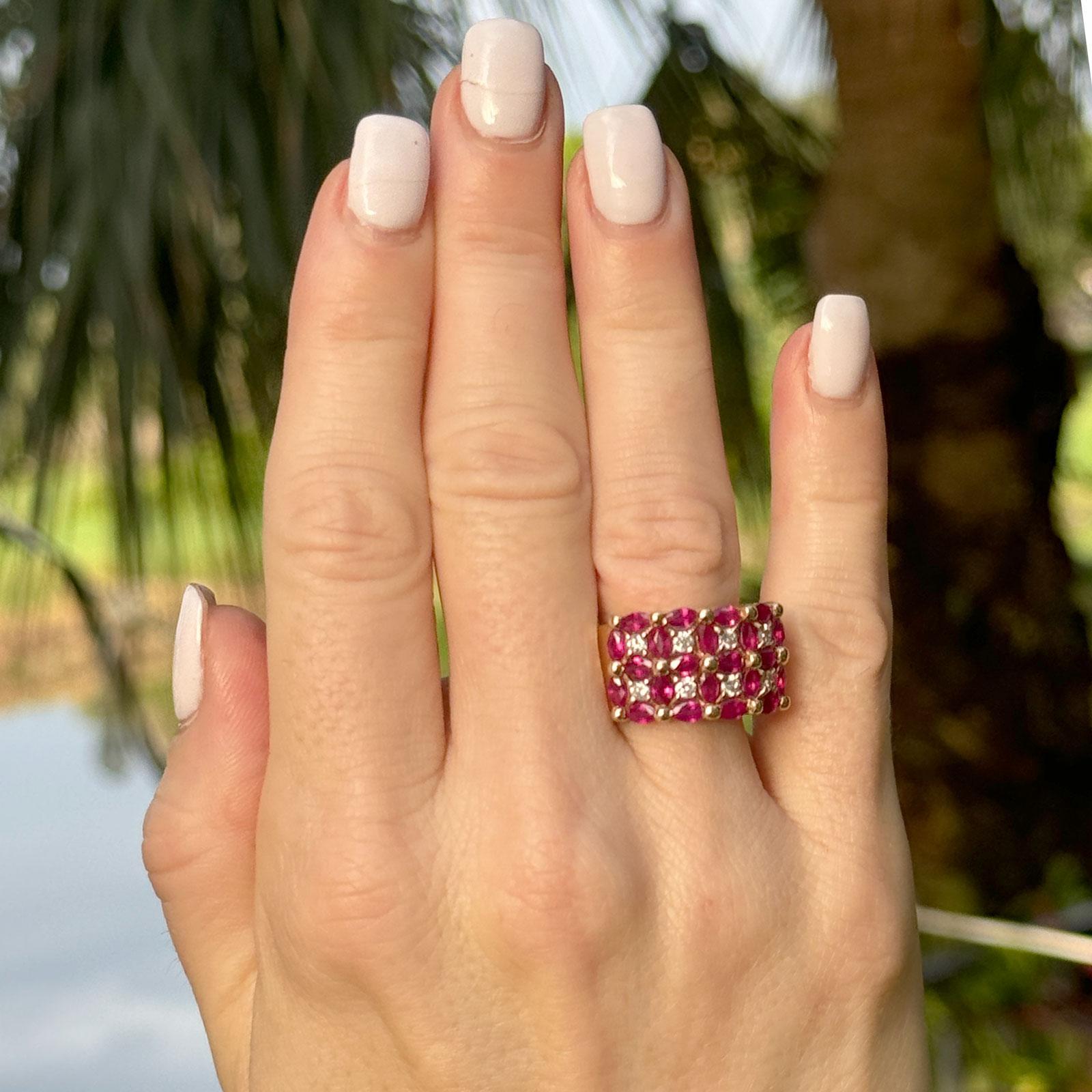 This 14 karat yellow gold band ring features a captivating combination of rubies and diamonds, creating a classic yet vibrant look. The ring showcases 8 round brilliant cut diamonds totaling 0.40 carats, with H-I color and SI clarity, adding a