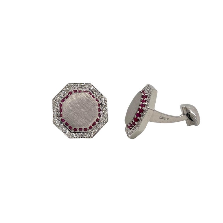 One pair of ruby and diamond 18k white gold octagonal shape cufflinks. 
Cufflinks contain 64 round brilliant diamonds 0.70tcw and 48 round brilliant rubies 0.60tcw. 
Diamonds are near colorless and VS2 in clarity. Cufflinks have a satin finish,