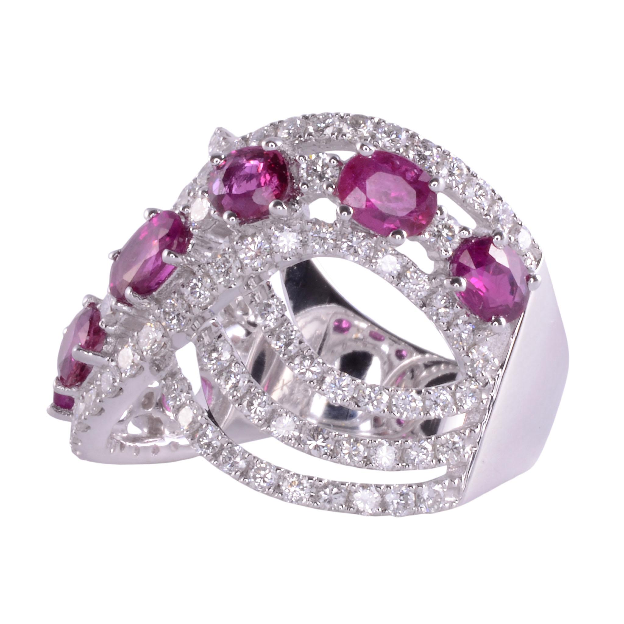 Estate ruby & diamond 18KW wide ring. This 18 karat white gold ring features seven oval rubies at 2.06 carat total weight. The rubies are accented with 1.29 carats of round brilliant diamonds having VS clarity and G-H color. This ruby ring weighs