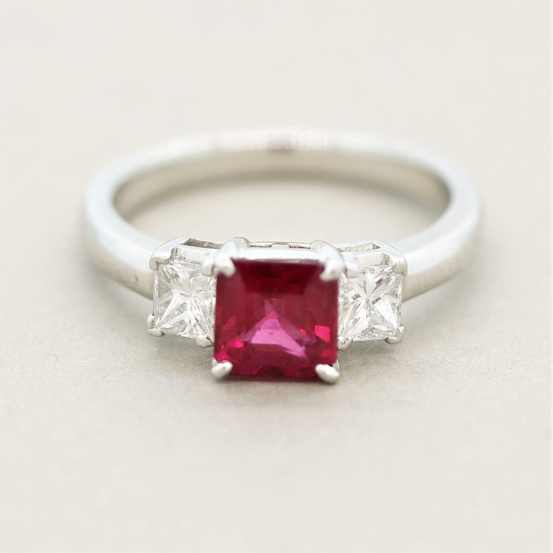 A classic 3-stone design featuring a 0.98 carat square shaped ruby. It has a bright fine vivid red color and is free of any eye-visible inclusions allowing the stones natural brilliance to shine. It is accented by two princess-cut diamonds set on