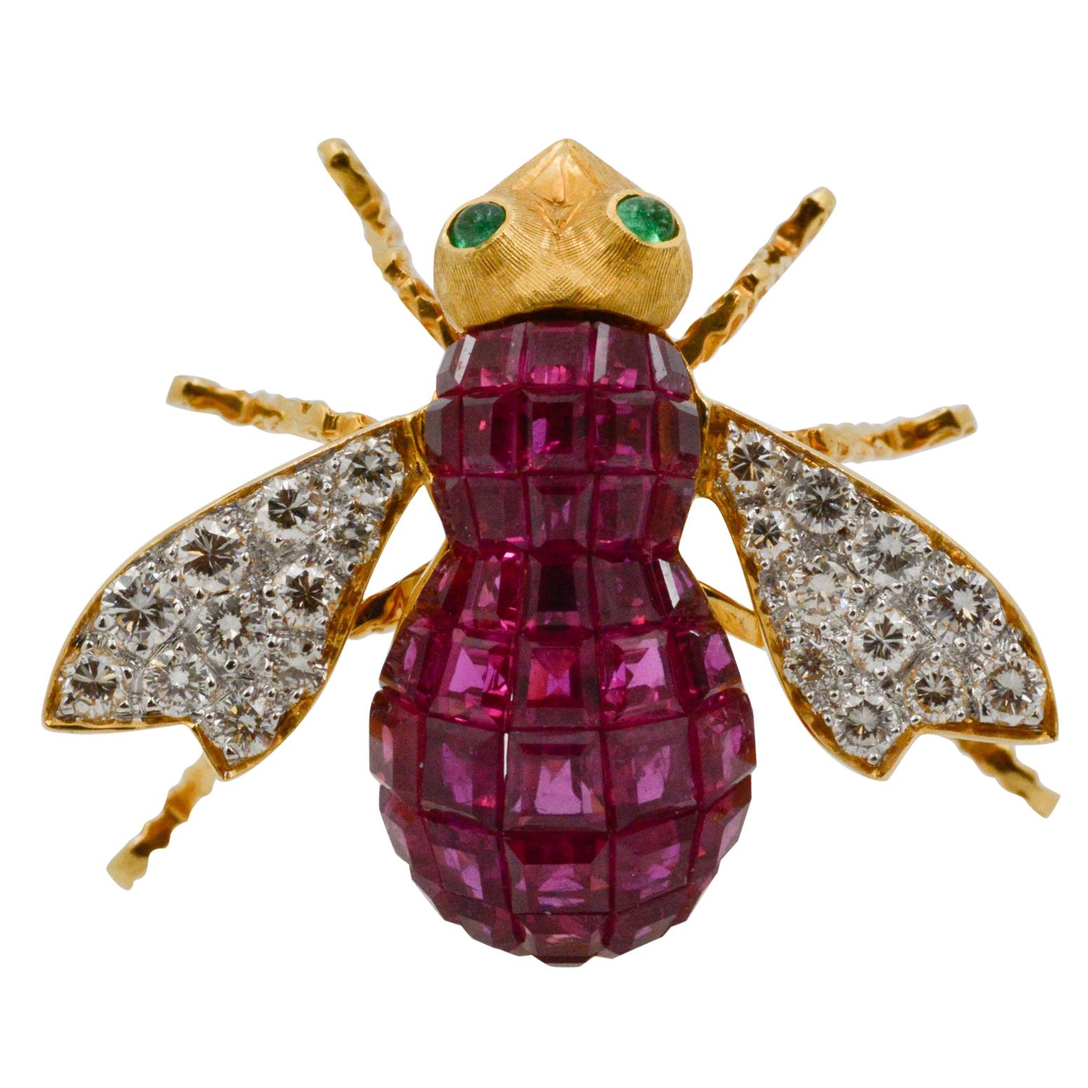 This charming French bee pin is adorned in 18k yellow old and features 43 square rubies, weighing a total of 3 carats. 22 round brilliant cut diamonds are delicately placed on the wings of the bee, weighing a total of .30 carats with D color and VS