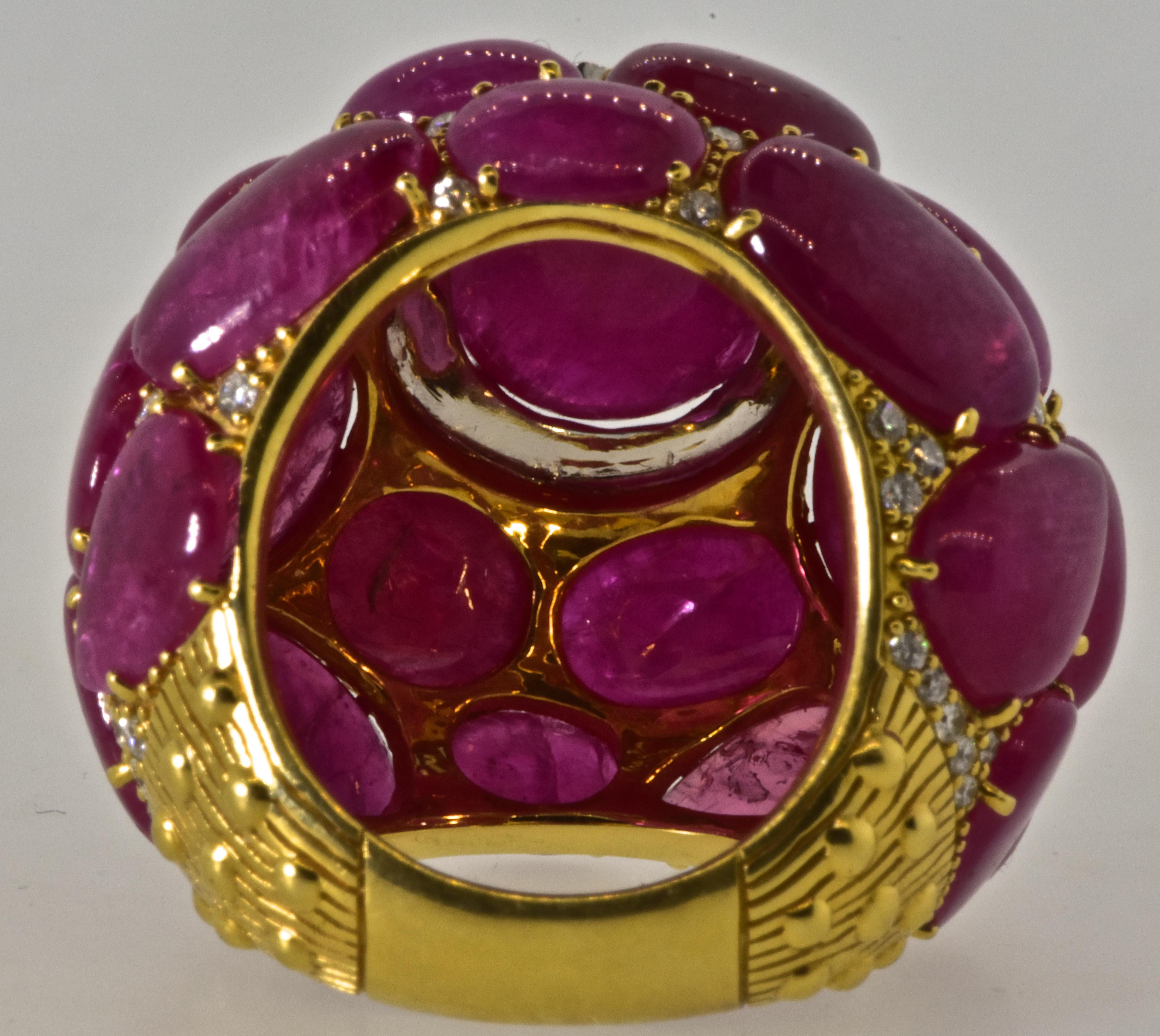 Ruby, diamond and 18K yellow gold large dome ring with wonderful presence.  The natural bright red rubies weigh exactly 45.62 cts.  These natural stones are well matched and - bright and vivid red.  The center ruby weighs 8.11 cts.  The round