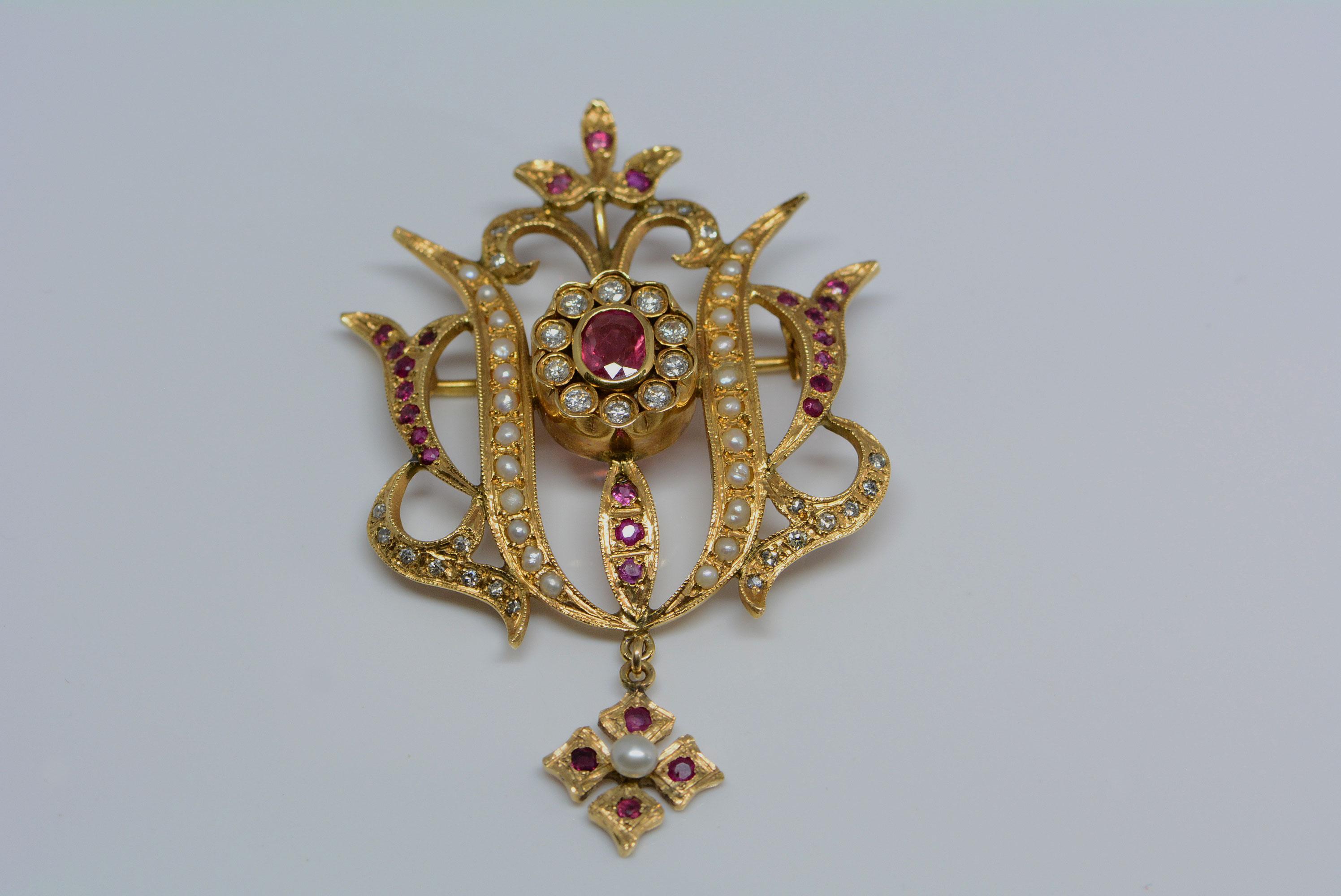 This brooch reminds us of something you would see out of the tudor time period with the combination of pearls, rubies, and diamonds. It really makes a statement and it can also be worn as either a pendant or a brooch. The brooch is made from 14