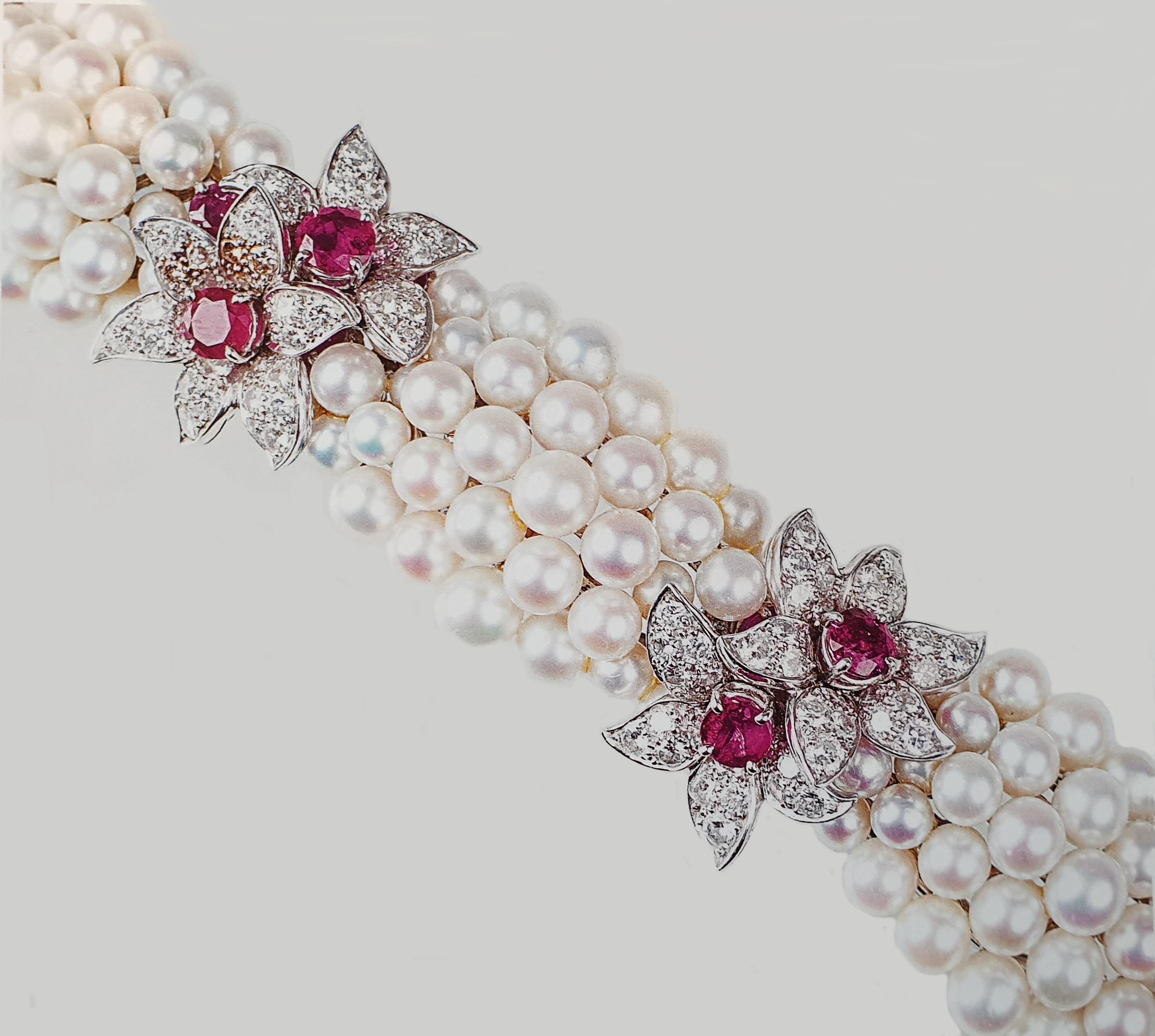 Germany, 1960s. 18 K gold. Flower shape. Composed of cultured pearls with diameter of 4-6,5 mm, 19 rubies weighing circa 5,1 carats and 168 brilliant-cut diamonds weighing approximately 6,60 carats, clarity VVS-VS, color G-H. 
Length: 6.89 in ( 17,5