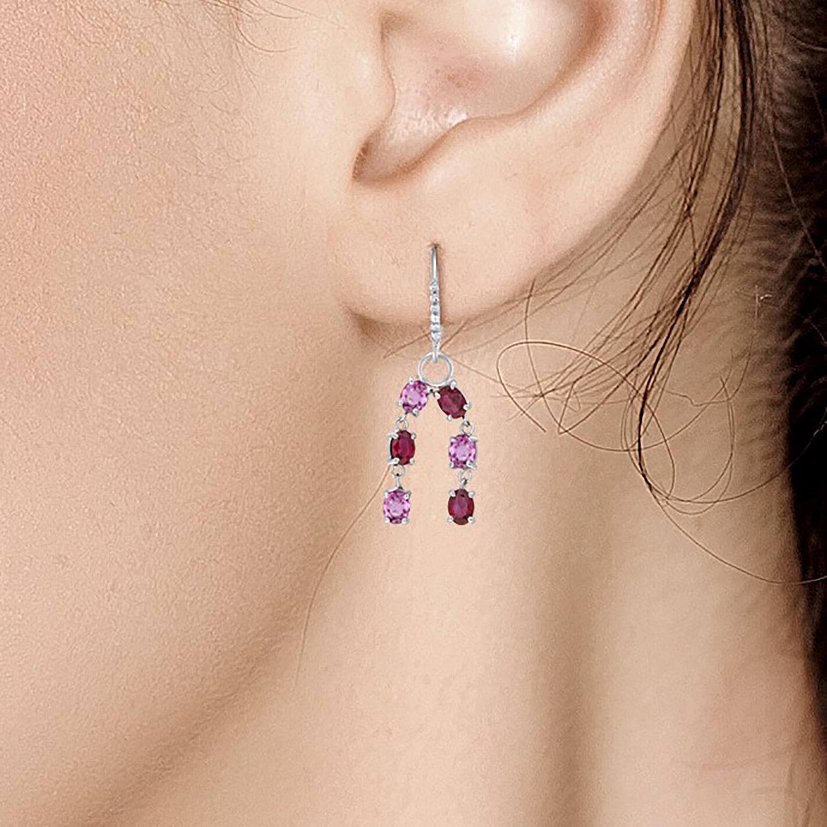 Fourteen karats white gold diamond, ruby, and pink sapphire hoop earrings 
Earrings measuring two inches long
Six oval shapes pink sapphire weighing 2.80 carat
Six oval-shaped ruby weighing 2.60 carat
Diamond weighing 0.30 carat 
One of a kind