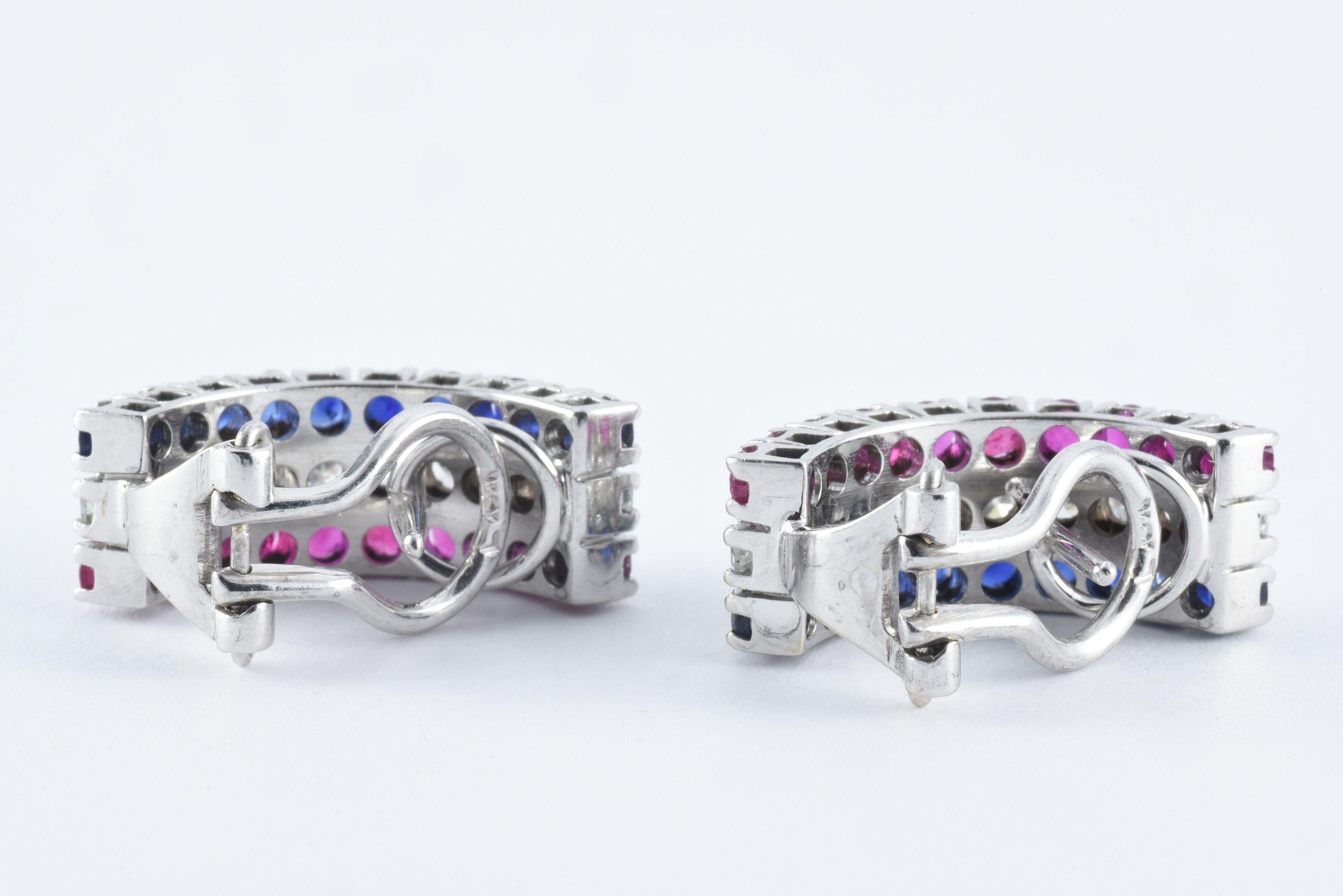 These beautiful huggie earrings made in France and reminiscent of the French flag feature three rows of stones. Each earring is set with ten single cut diamonds totaling approximately 0.50 carats in the middle, flanked on each side by ten round