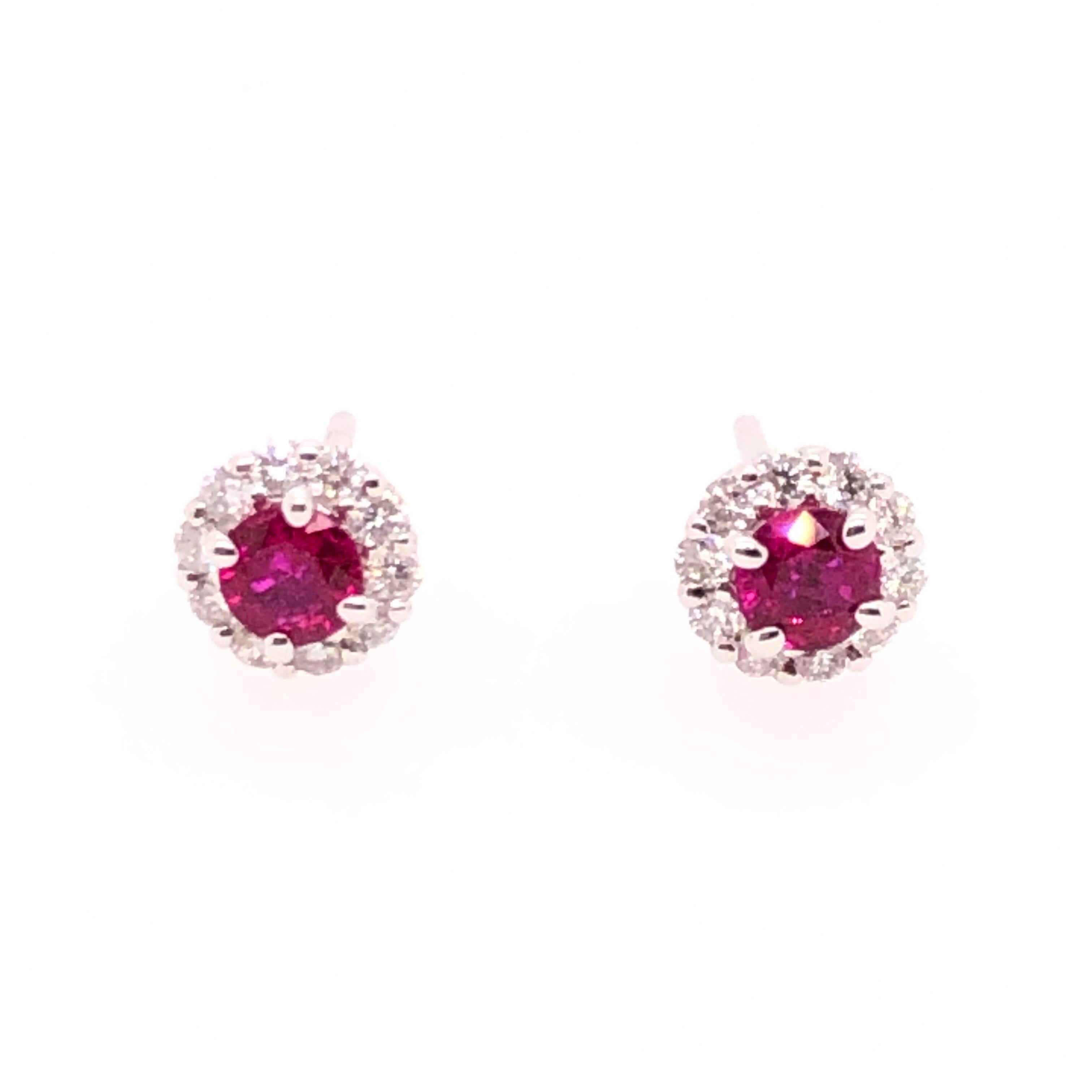 A touch of color in a timeless setting, these beautiful bright rubies nestled in a ring of diamonds are the perfect accent. This classic design is versatile yet elegant, for a timeless feminine. 

This pair of 14K white gold earring studs have a