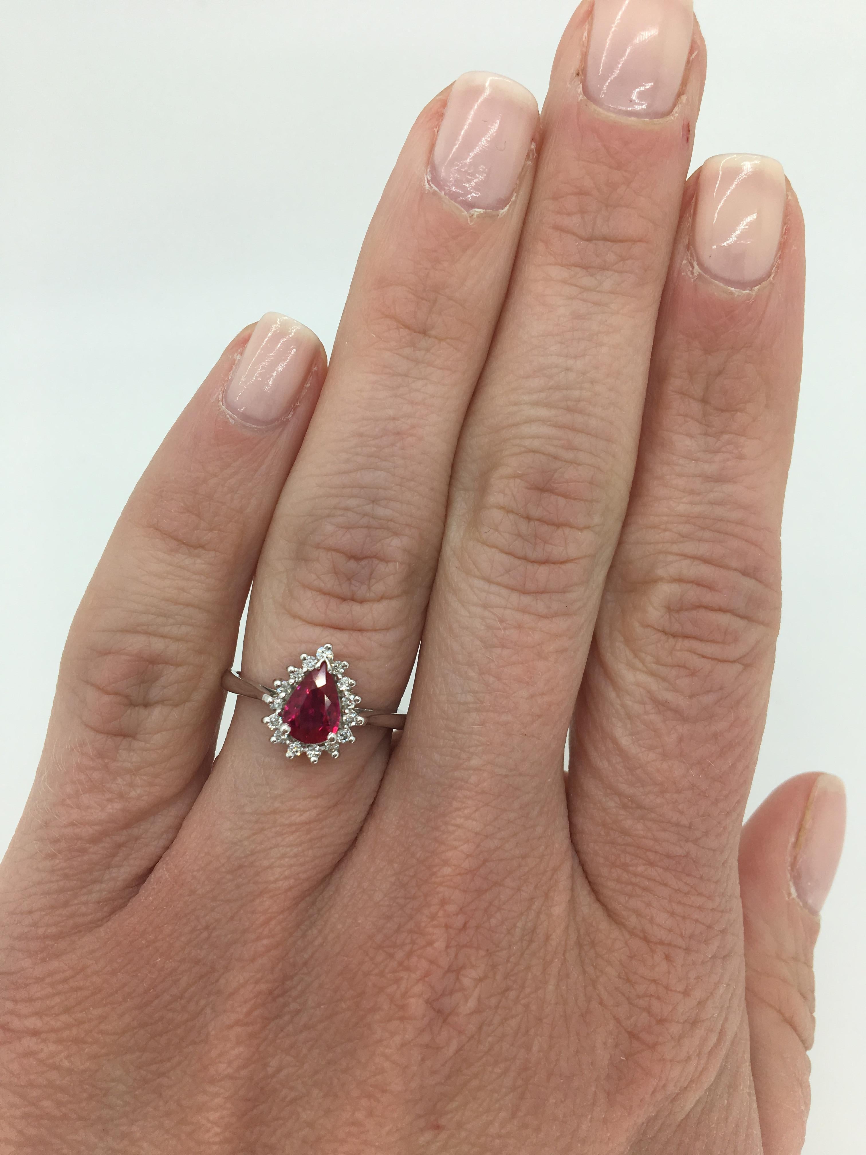 Ruby and Diamond halo style cocktail ring mounted in 14k white gold.

Gemstone: Ruby & Diamond
Gemstone Carat Weight: Approximately .68CT Pear Cut Ruby
Diamond Carat Weight: Approximately .18CTW
Diamond Cut: Round Brilliant Cut
Color: Average