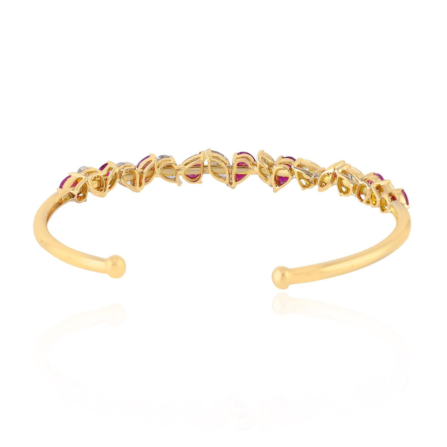 
Sweet and sassy Ruby Diamond pear and marquee shape Bangle in 18K Yellow Gold is perfect to stack and add some vibrant colors to your wrist.

18KT Gold: 9.382gms
Diamond: 2.33cts
Ruby: 3.099cts
