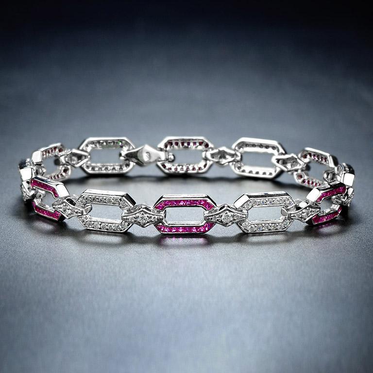 Featuring dazzling diamonds and rubies, this Art Deco-style bracelet is beautifully made. It is geometric in design and symmetrical. The diamonds are a total weight of 1.50 carat approximately and are estimated as G in color and VS in clarity. This