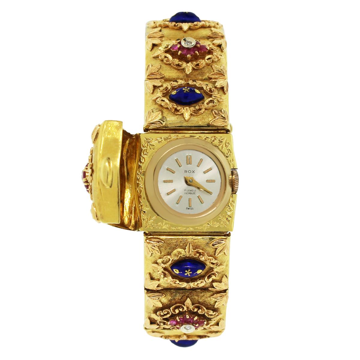 Case Material: 18k yellow gold
Case Diameter: 16mm
Dial: Off-white dial with yellow gold hands and hour markers. When closed, there is a diamond in the center of the bracelet that is approximately 0.10ctw
Bezel: 18k Yellow gold bezel
Bracelet: 18k