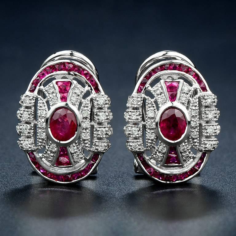 Oval Shape Earrings set with French Cut Burmese Ruby Total 50 pieces 2.50 Carat and sparkling by 76 pieces 0.41 Carat Diamonds. This earring was Set on 18K White Gold Clip-on Style.