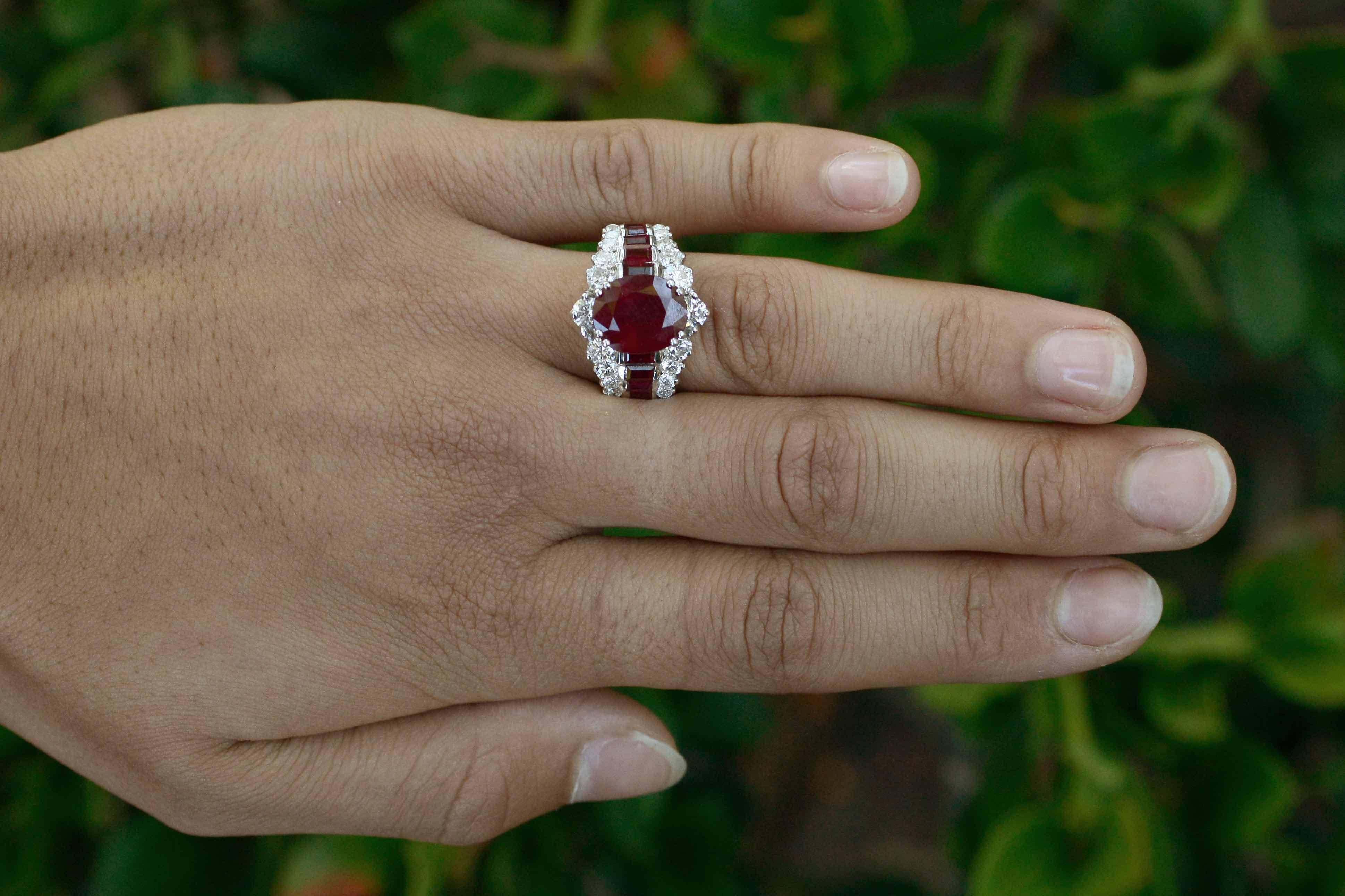 This captivating cocktail ring commands attention, centered by a luscious red ruby of 5.27 cts, the wide band cascades down the finger with a staircase of baguette rubies and sparkling round diamonds. This bauble would make for a glam gemstone