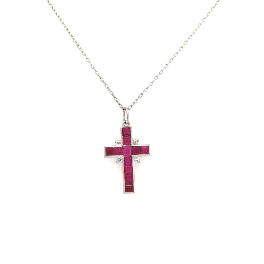 Exceptional emerald cut ruby cross with diamonds set in platinum. 1.25cts of rubies. Four diamonds frame the center of the cross. Perfect sparkling little jewel