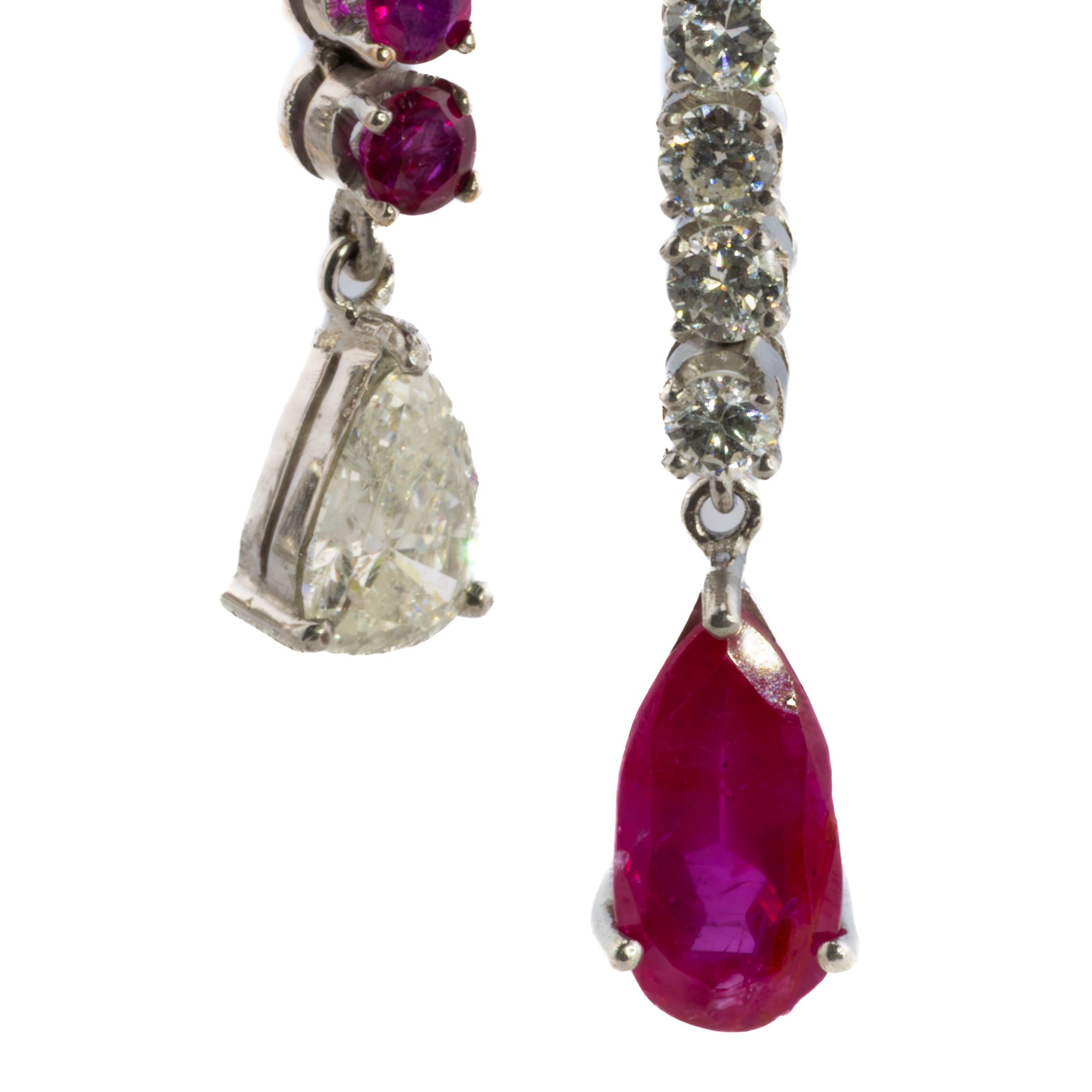 Ruby & Diamond Dangle Earrings

These stunning Ruby & Diamond Dangle Earrings are crafted in luxurious white gold and radiate a timeless charm. Each earring features an exquisite combination of gemstones, including two pear-shaped diamonds totaling