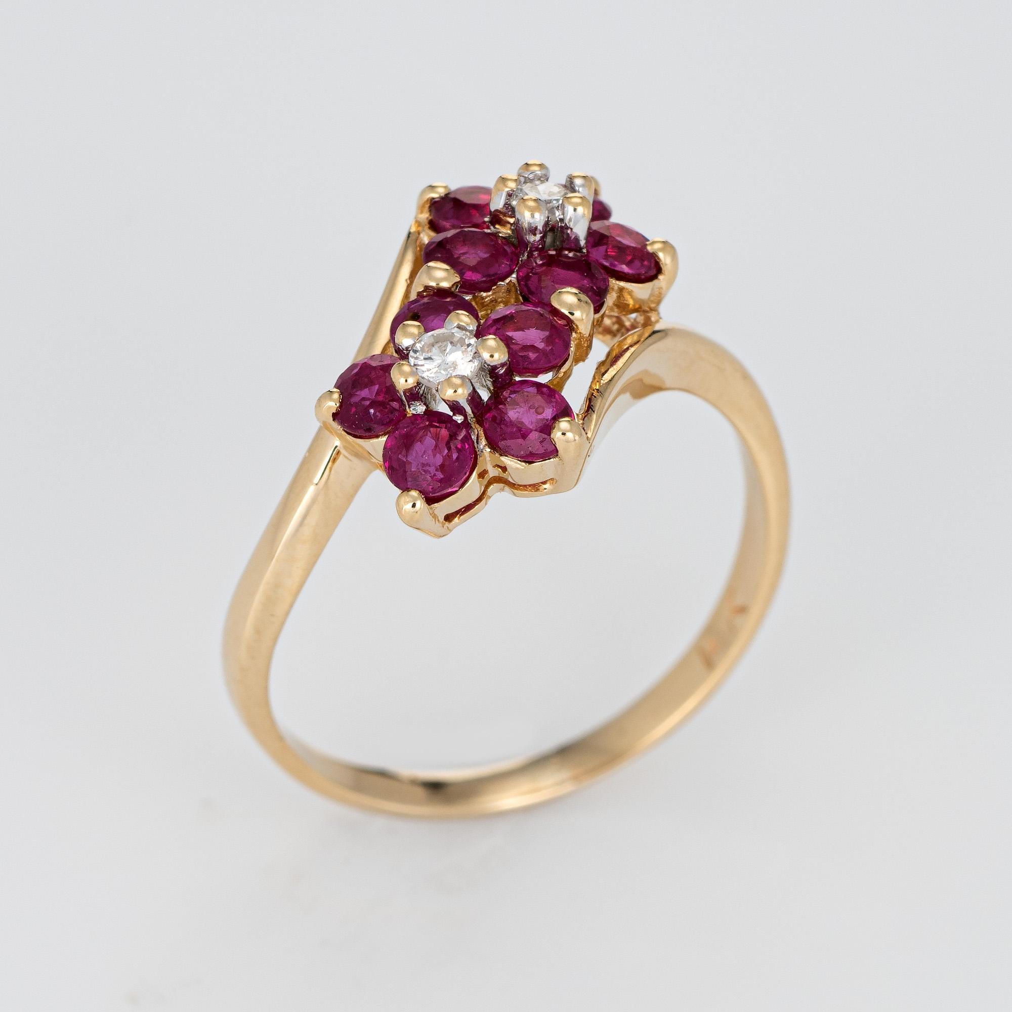 Finely detailed vintage ruby & diamond double flower ring crafted in 14k white gold. 

Two estimated 0.02 carat (each) round brilliant cut diamonds total an estimated 0.04 carats (estimated at H-I color and SI1-I1 clarity). 10 rubies are estimated