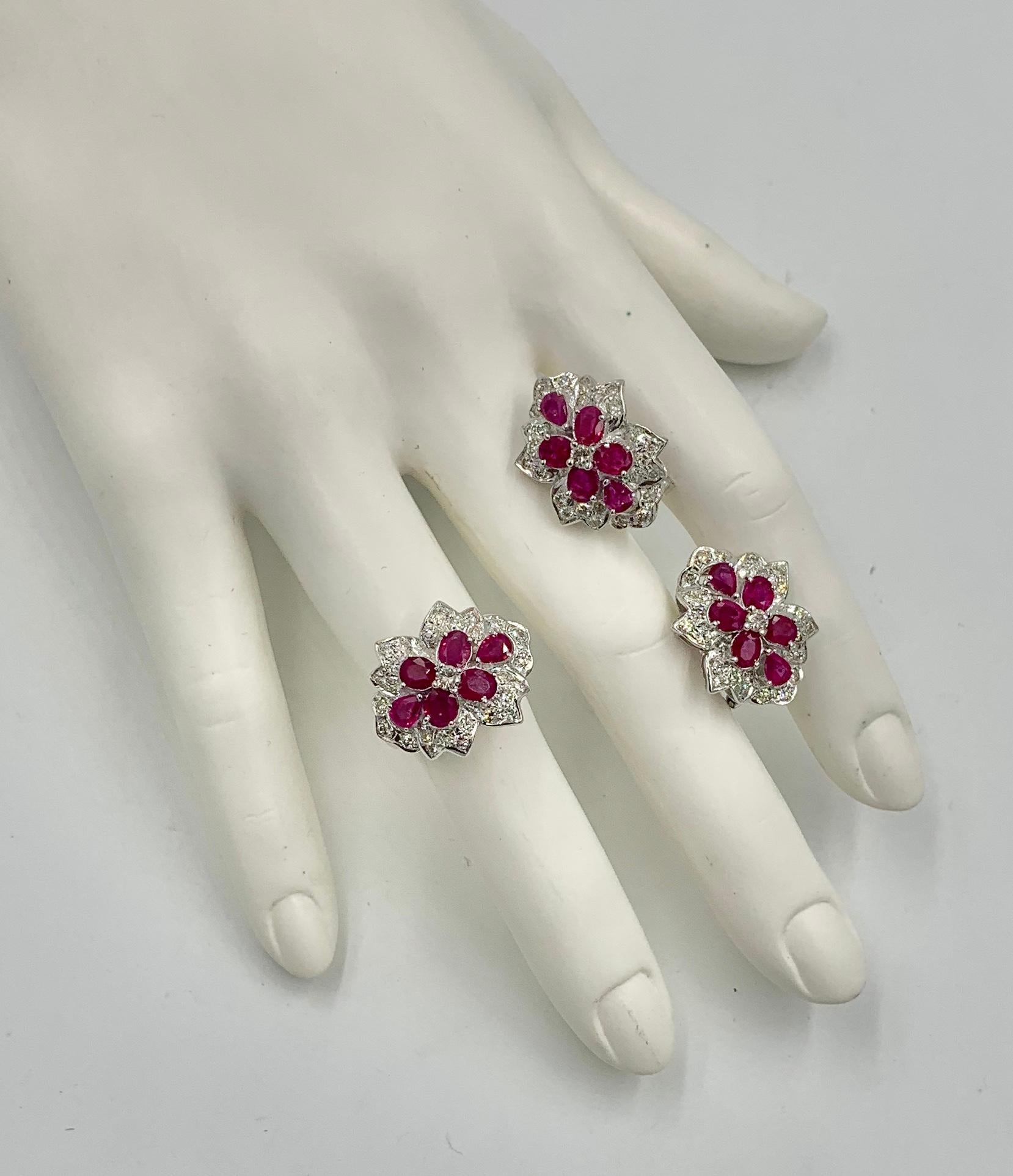This is a magnificent matching set of fine red Ruby and Diamond Earrings and Ring in 18 Karat White Gold.   The absolutely stunning earrings and ring feature the most gorgeous bright Raspberry Red Rubies. There are 12 Oval Faceted Rubies and 6 Pear