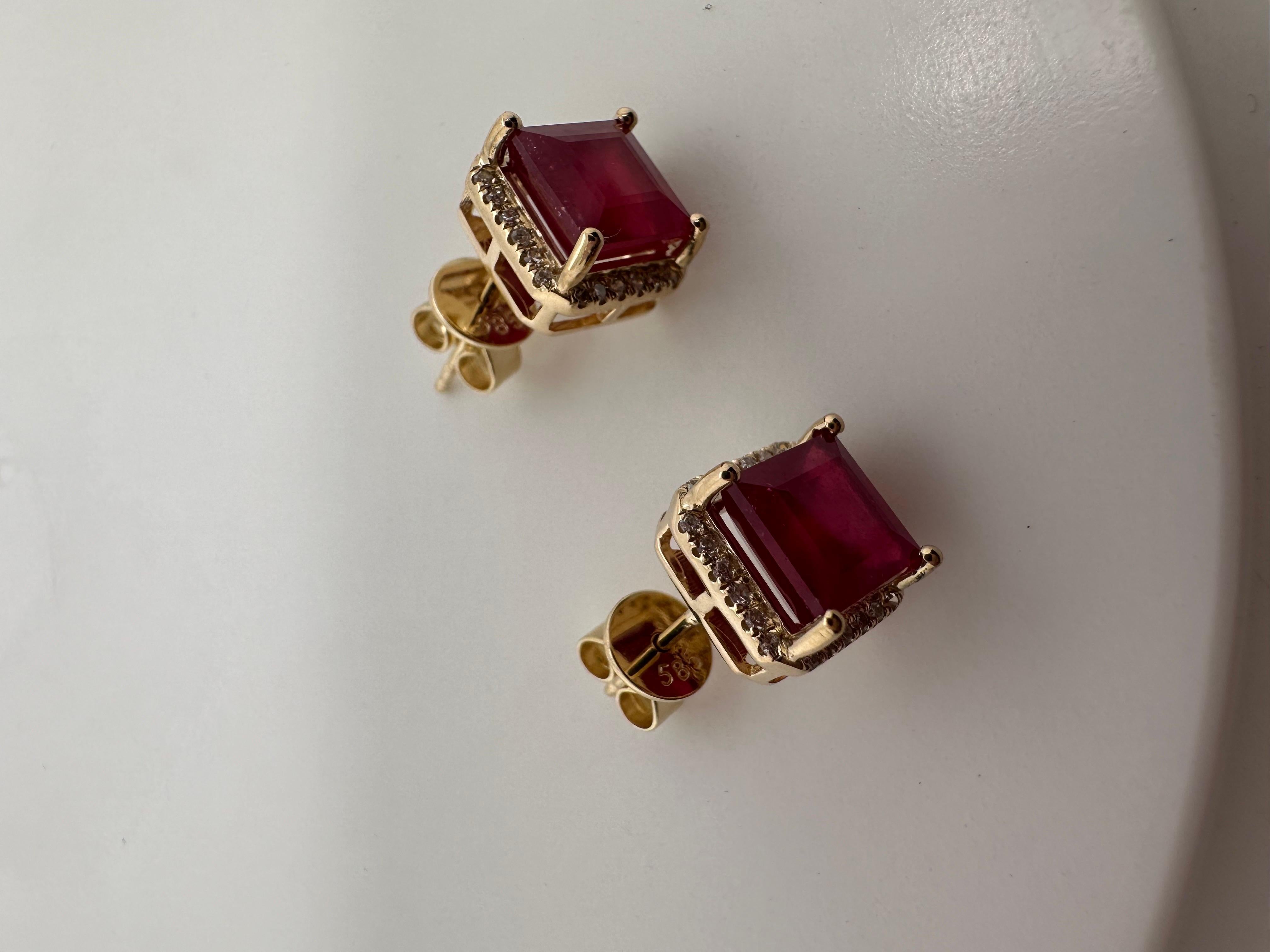 Matching pair of ruby earrings made with natural red rubies and natural diamonds in 14KT yellow gold.

Metal Type: 14KT

Natural Ruby(s): 
Color: Pinkish Red
Cut:Square 7mm
Clarity: Slightly Included (enhanced)
NATURAL DIAMOND
Color: G 
Cut: Round