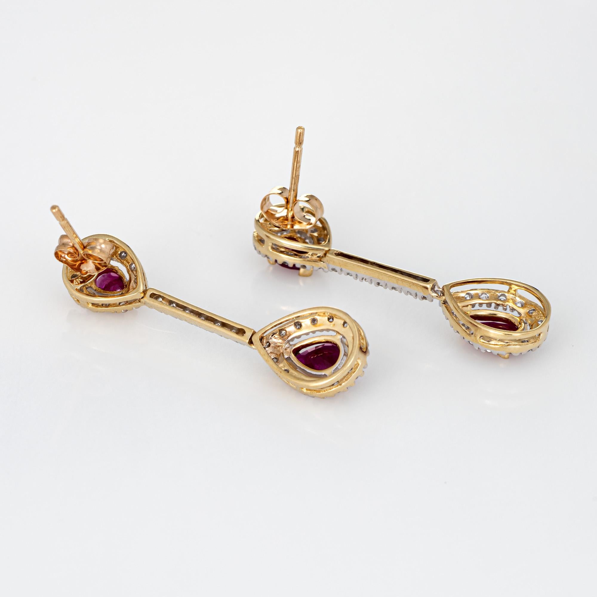 Elegant pair of vintage ruby & diamond earrings crafted in 14k yellow gold. 

Two rubies are estimated at 0.15 carats each (upper) and 0.25 carats each (lower). The rubies total an estimated 0.80 carats. The diamonds total an estimated 0.48 carats