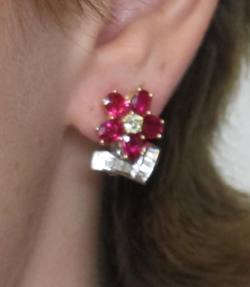 These gorgeous ruby and diamond flower earrings are an absolute must have. Ten rich, red rubies, (3.8X5mm each/ 3.86 carats total) form the flower petals, two brilliant cut canary diamonds (0.38 carats total) are set at the center of the flower,