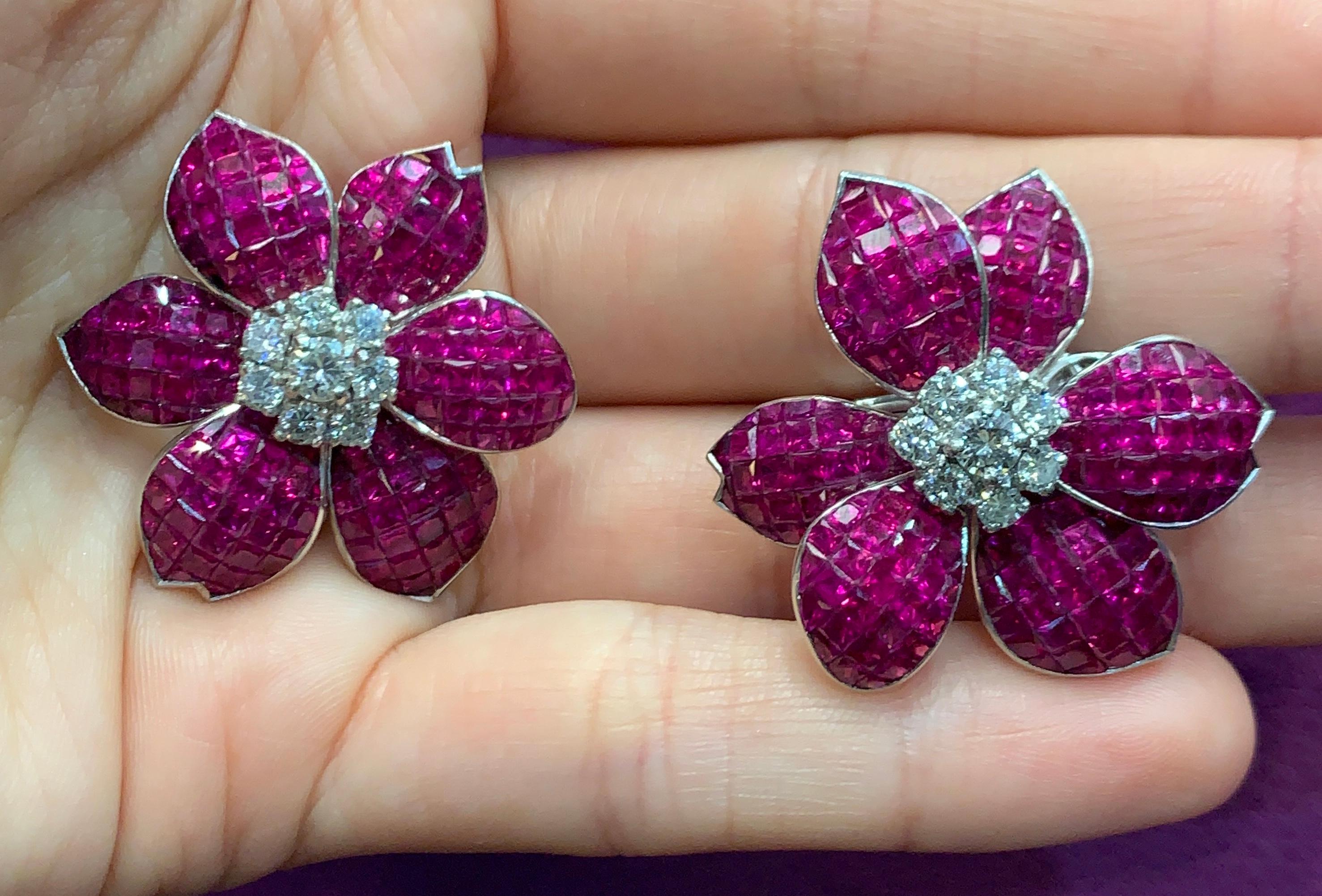 Ruby & Diamond Flower Earrings Set in Platinum made circa 1970
16 round cut diamonds & 344 rubies 
Ruby Weight: approx 38.05 CT’s 
Diamond Weight: approx 1.43 CT’s 
Back Type: clip on
Measurements: 1” long 