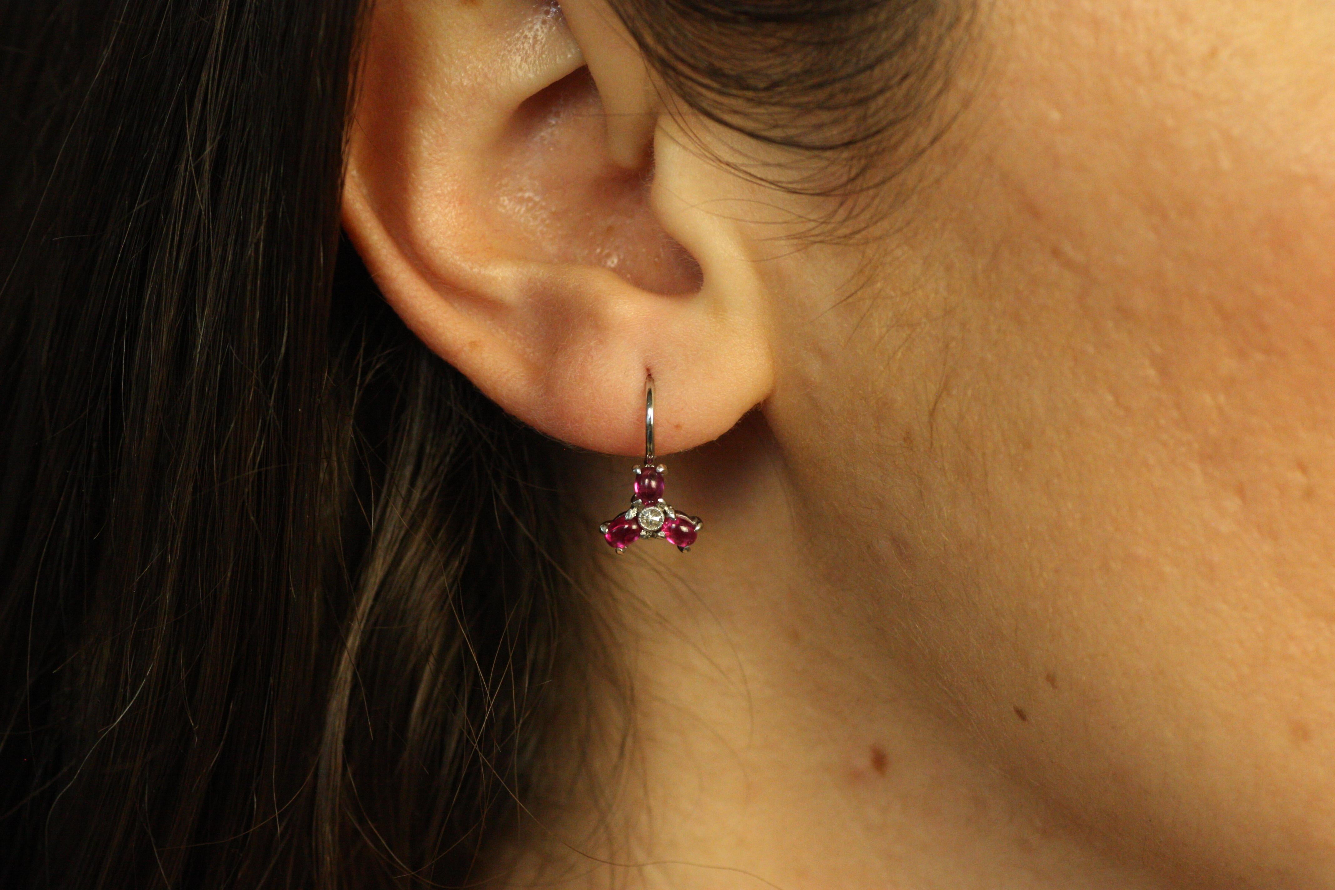These Ruby Diamond Triangle Earrings bring together the vibrancy of Burma rubies and the sparkle of diamonds. Each earring features three beautifully matched rubies arranged in a triangular pattern, accented by two sparkling diamonds. Set on