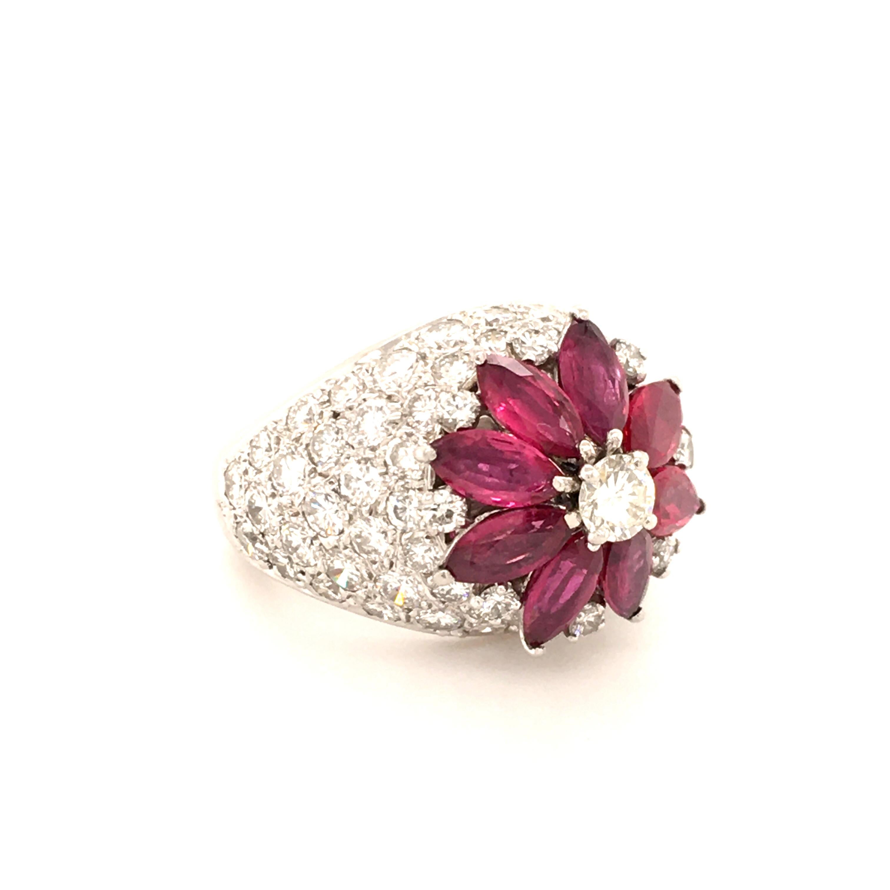 A beautiful platinum ring featuring 8 vivid red marquise shaped rubies, total weight approximately 2.80 carats. Surrounded by 73 brilliant-cut diamonds of G and H color and vs clarity, total weight approximately 3.27 carats.

Size: 51 / US 6
