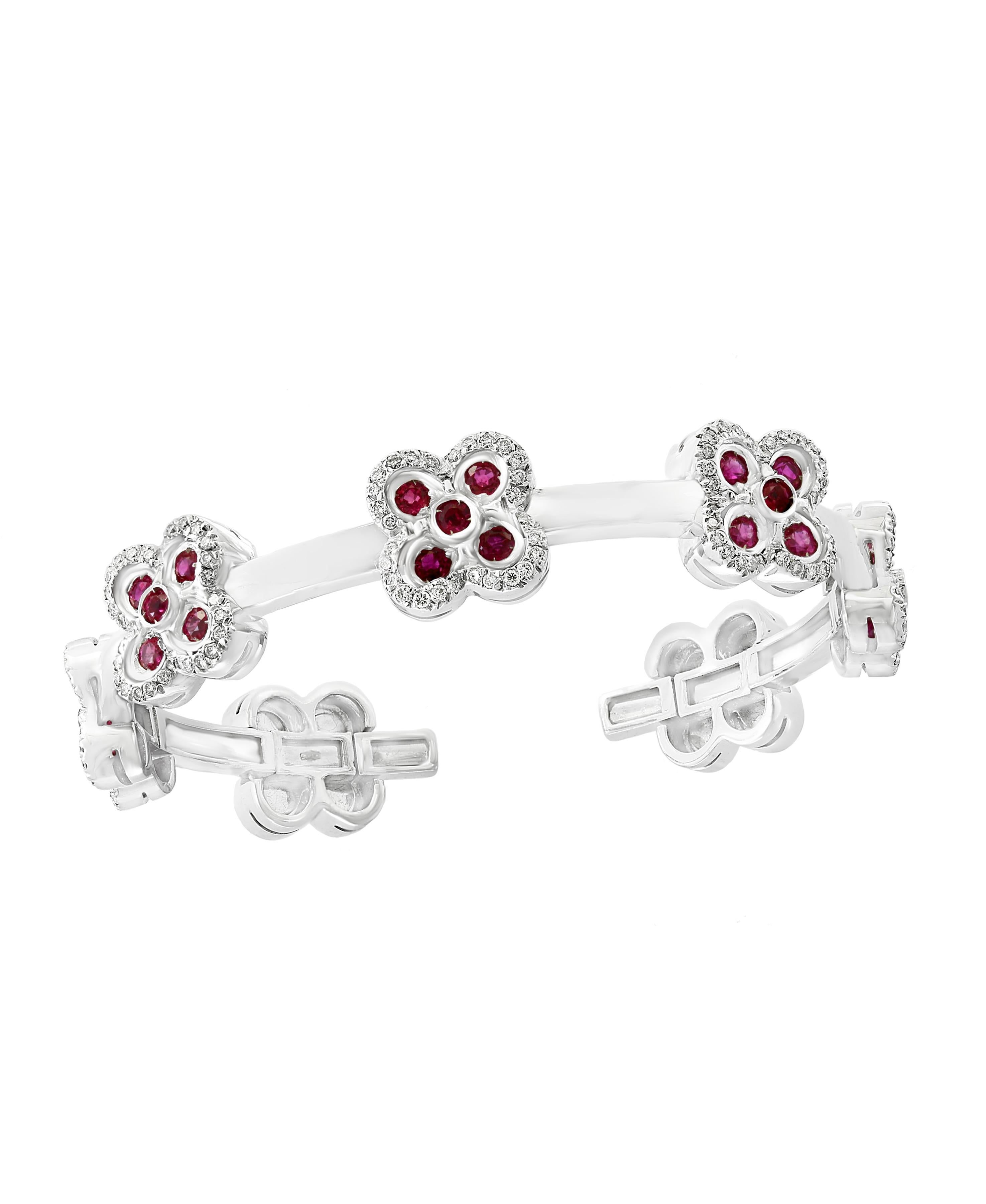 Ruby & Diamond & Gold 37 Grams Cuff Bangle /Bracelet In 18 Karat White Gold
It features a bangle style Bracelet crafted from an 18 Karat White gold and embedded with 7 Flowers out of which 5 flowers have Ruby petals surrounded by round brilliant