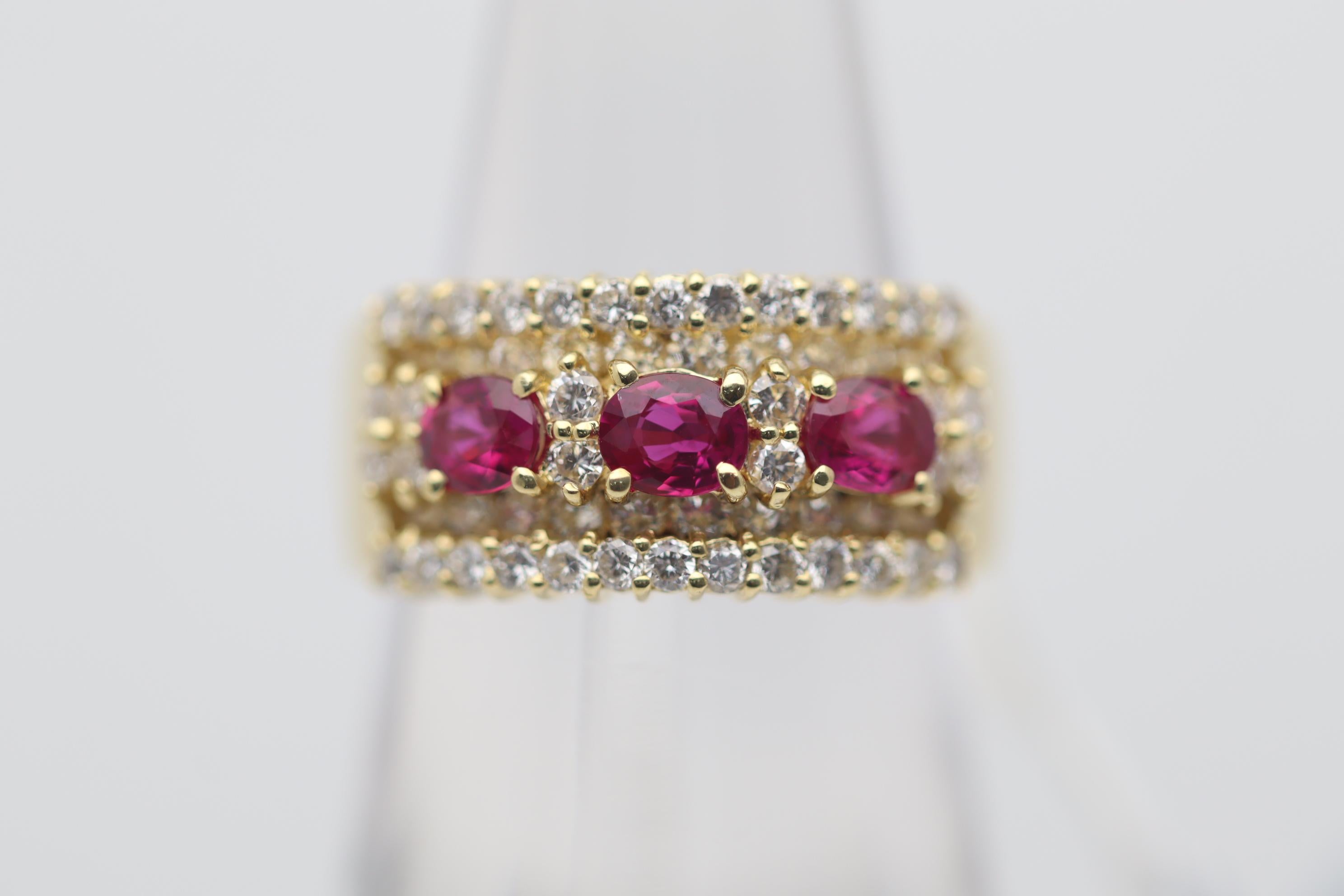 A chic and sexy ring featuring 3 gem quality vivid red rubies. The rubies weigh a total of 1.01 carats and each have an intense pigeon blood color with excellent brilliance. They are complemented by 1.17 carats of round brilliant-cut diamonds set