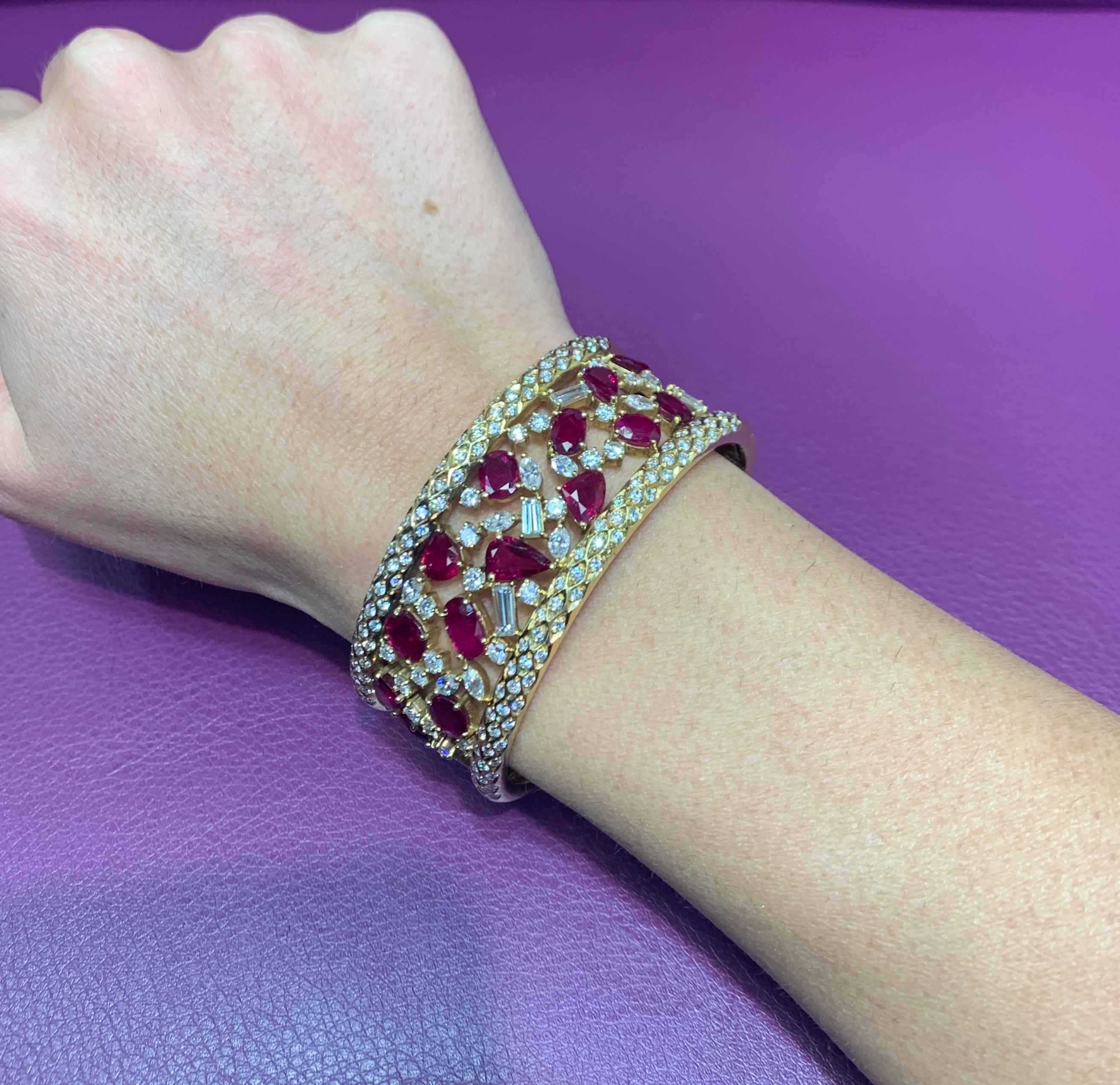 Ruby & Diamond Gold Bangle Bracelet 
14 rubies weigh approximately 7 carats
5 baguette diamonds, 10 marquise diamonds, 25 round diamonds, 128 pave diamonds altogether weigh approximately 5 carats
Measurements: 2.25