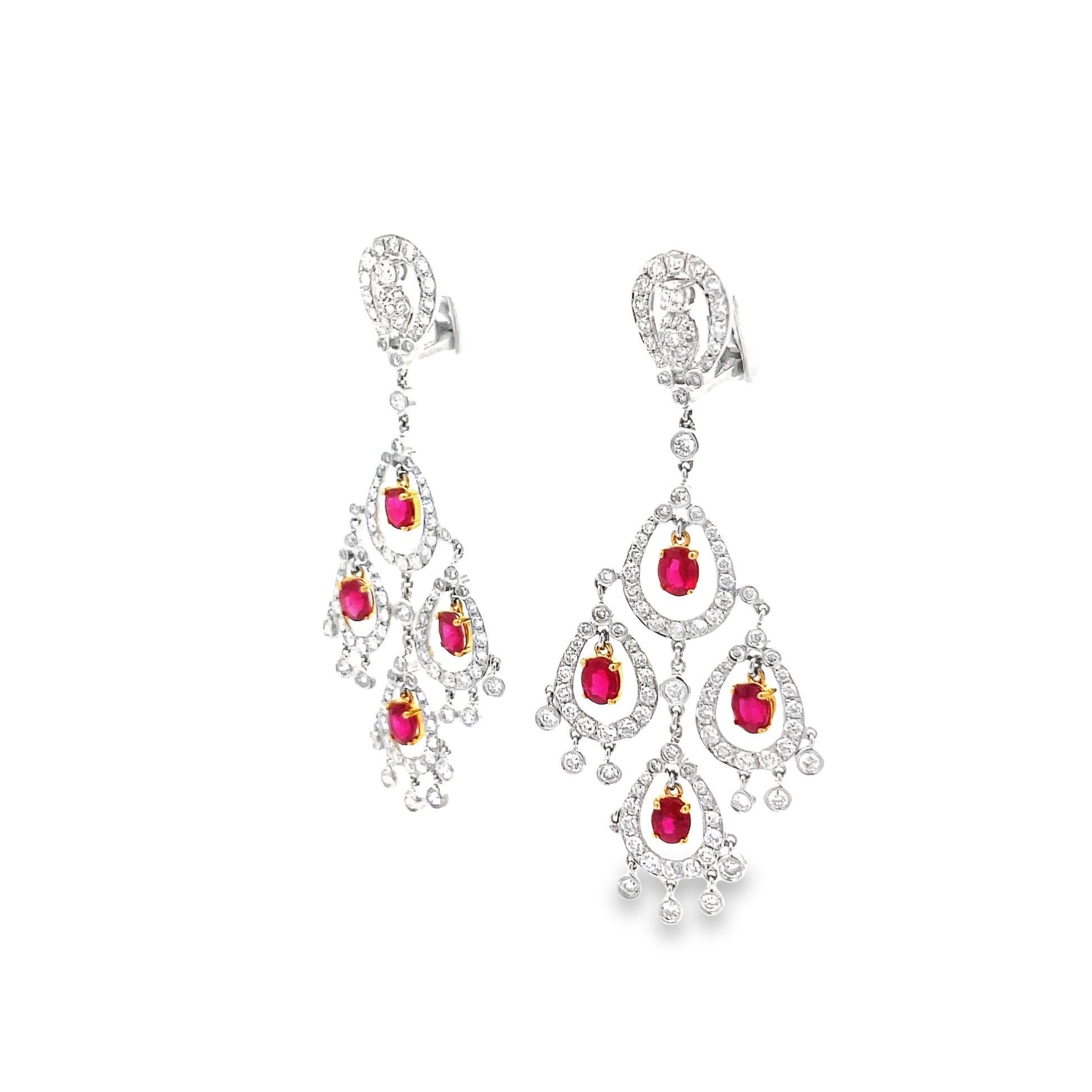 A lovely pair of gold chandelier earrings featuring 4.30 carats of VS quality round cut diamonds and 4.06 carats of vivid red oval shaped rubies. The diamonds are set in 18K white gold while the rubies are set in 18K yellow gold, a great two-tone