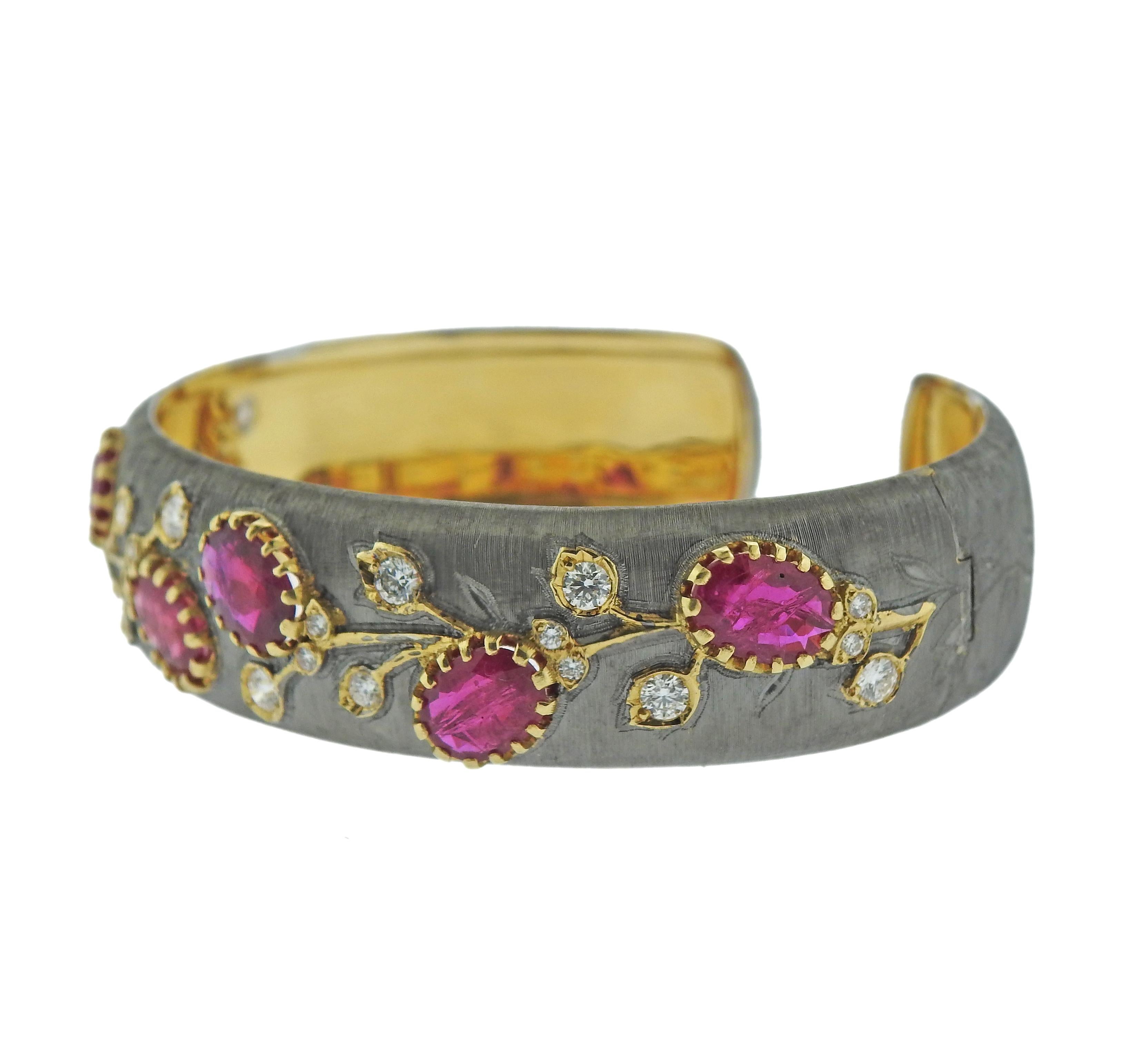 18k yellow and white brushed gold cuff bracelet, set with vibrant rubies and approx. 0.90ctw in diamonds. Bracelet will fit approx. 7